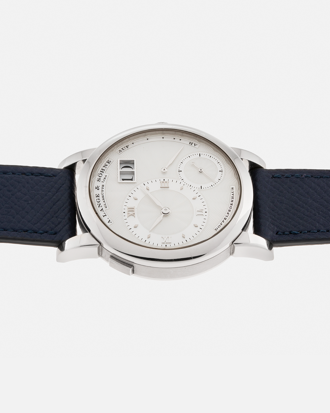 Brand: A. Lange & Söhne Year: 2000’s Model: Lange 1 Soirée Reference Number: 110.030 Material: 18-carat White Gold Movement: A. Lange & Söhne Cal. L901.5, Manual Winding Case Dimensions: 38.5mm x 9.8mm Lug Width: 20mm Strap: Nostime Navy Grained Calf Leather Strap with Signed 18-Carat White Gold Tang Buckle