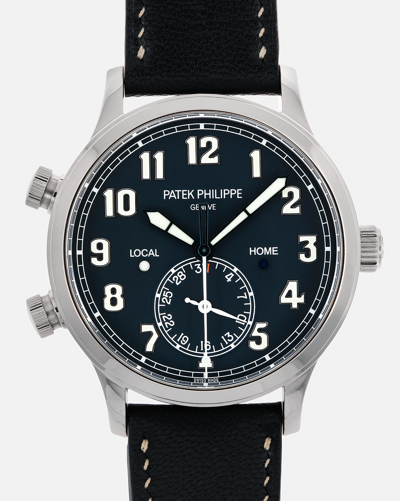 Brand: Patek Philippe Year: 2019 Model: Calatrava Pilot Travel Time Reference: 5524G Material: 18-carat White Gold Movement: Patek Philippe Cal. 324 S C FUS, Self-Winding Case Diameter: 42mm Lug Width: 22mm Strap: Patek Philippe Brown Leather Strap with Signed 18-carat White Gold Tang Buckle and Unbranded Custom Made Navy Blue Leather Strap