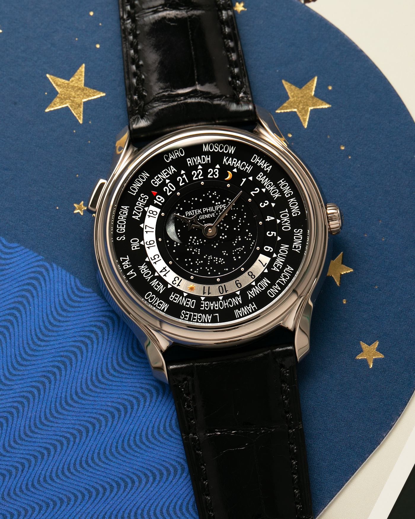 Brand: Patek Philippe Year: 2015 Model: World Time Moon, Limited Edition of 1300 pieces Reference Number: 5575G Material: 18-carat White Gold Movement: Patek Philippe Cal. 240 HU LU Micro-Rotor, Self-Winding Case Diameter: 40mm Lug Width: 20mm Strap: Patek Philippe Black Alligator Leather Strap with Signed / Engraved 18-carat White Gold Deployant Clasp