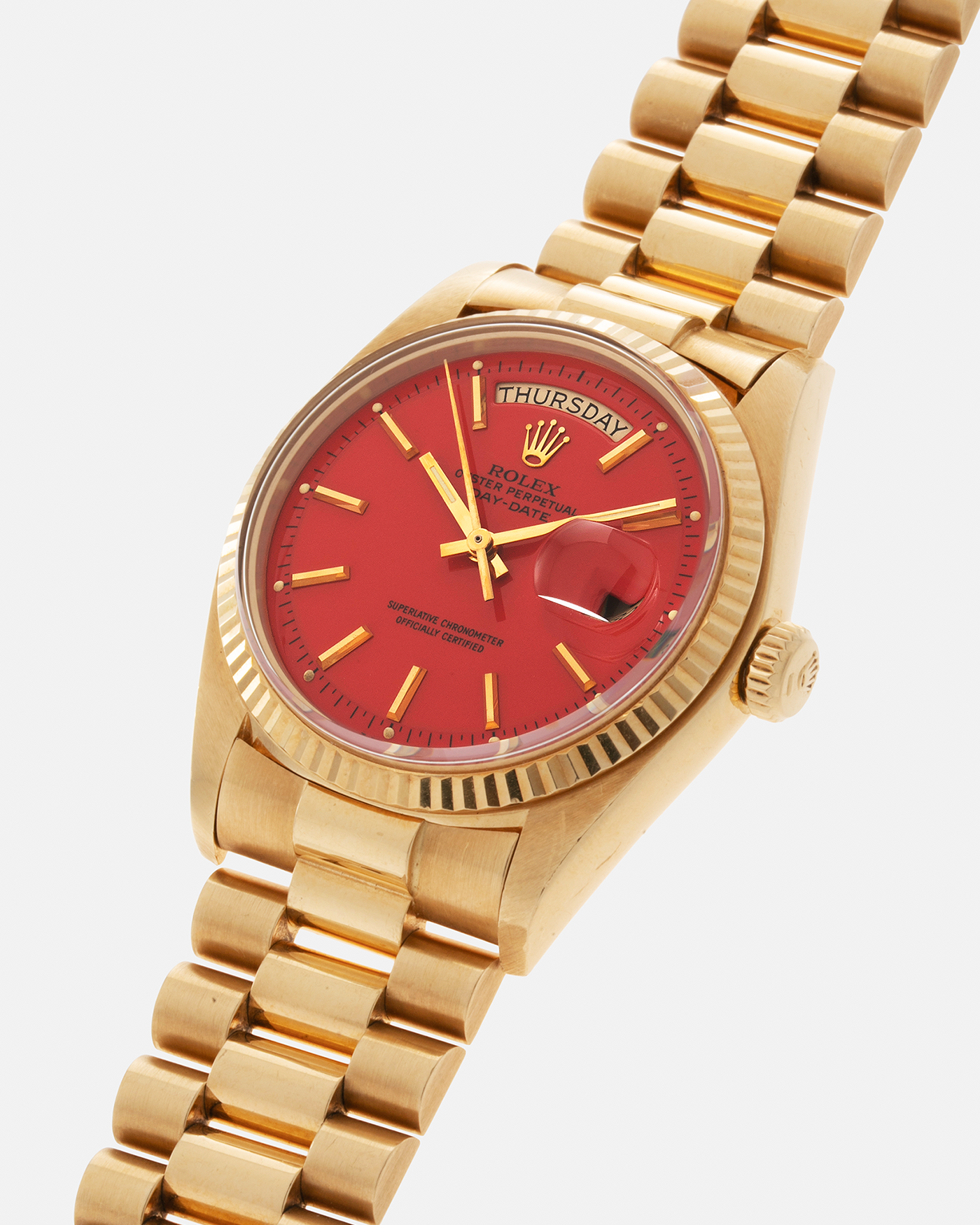 Brand: Rolex Year: 1978 Model: Day-Date, Coral Red ‘Stella’ Reference Number: 1803 Serial: 510XXXX Material: 18-carat Yellow Gold Movement: Rolex Cal. 1556, Self-Winding Case Diameter: 36mm Lug Width: 20mm Bracelet: Rolex 18-carat Yellow Gold ‘F18000’ Stamped Presidential Bracelet with ‘55’ Curved End Links