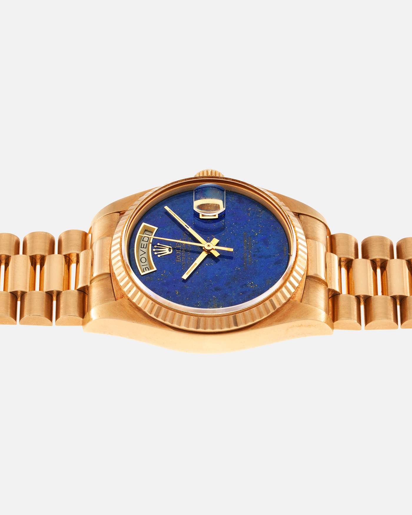 Brand: Rolex Year: 1979 Model: Day-Date, ‘Lapis Lazuli’ Reference Number: 18038 Serial: 612XXXX Material: 18-carat Yellow Gold Movement: Rolex Cal. 3055, Self-Winding Case Diameter: 36mm Lug Width: 20mm Bracelet: Rolex ‘8385’ 18-carat Solid Gold Presidential Bracelet with ‘55’ Curved End Links