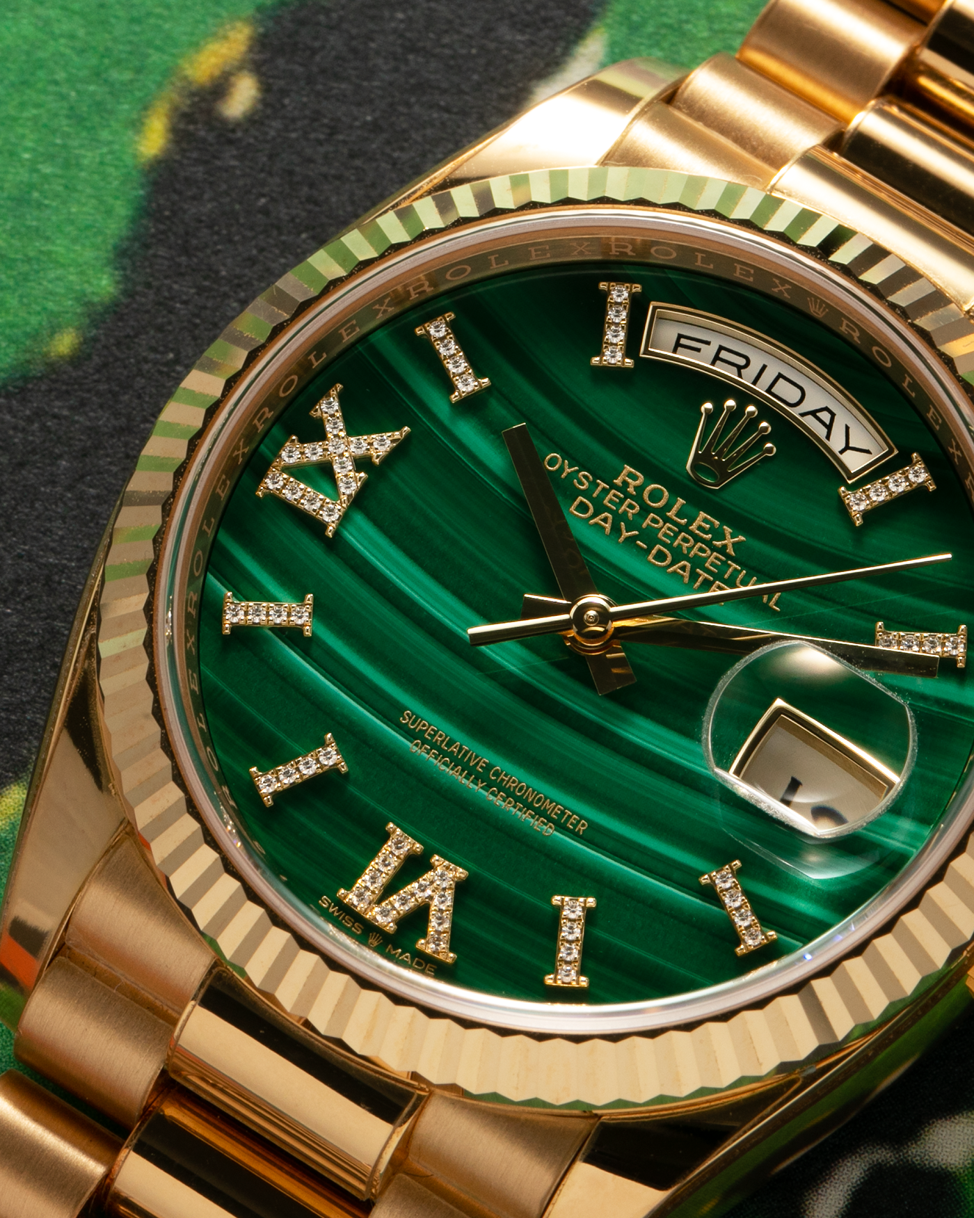 Brand: Rolex Year: 2021 Model: Day-Date 36 ‘Malachite Diamond’ Reference Number: 128238 Serial Number: 6H47XXXX Material: 18-carat Yellow Gold Case, Green Malachite Dial, Factory Set Diamond Roman-Style Hour Markers Movement: Rolex Cal. 3255, Self-Winding Case Diameter: 36mm Bracelet: Rolex Presidential Bracelet in 18-carat Yellow Gold
