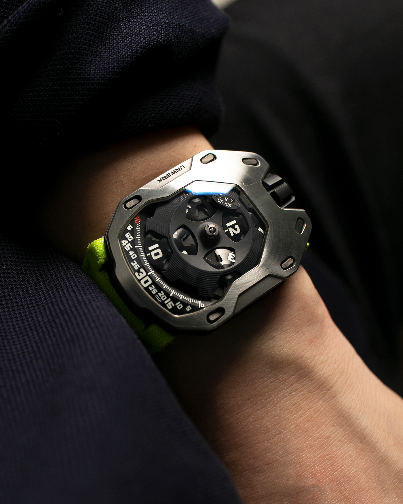 Brand: Urwerk Year: 2014 Model: UR105M “Iron Knight”, Limited to 77 pieces Material: Stainless Steel, Titanium Movement: Urwerk Cal. 5.01, Manual-Winding Case Dimensions: 39.50mm x 53mm x 16.65mm Strap: Urwerk Fluorescent Yellow Textile Strap with Signed Titanium Tang Buckle