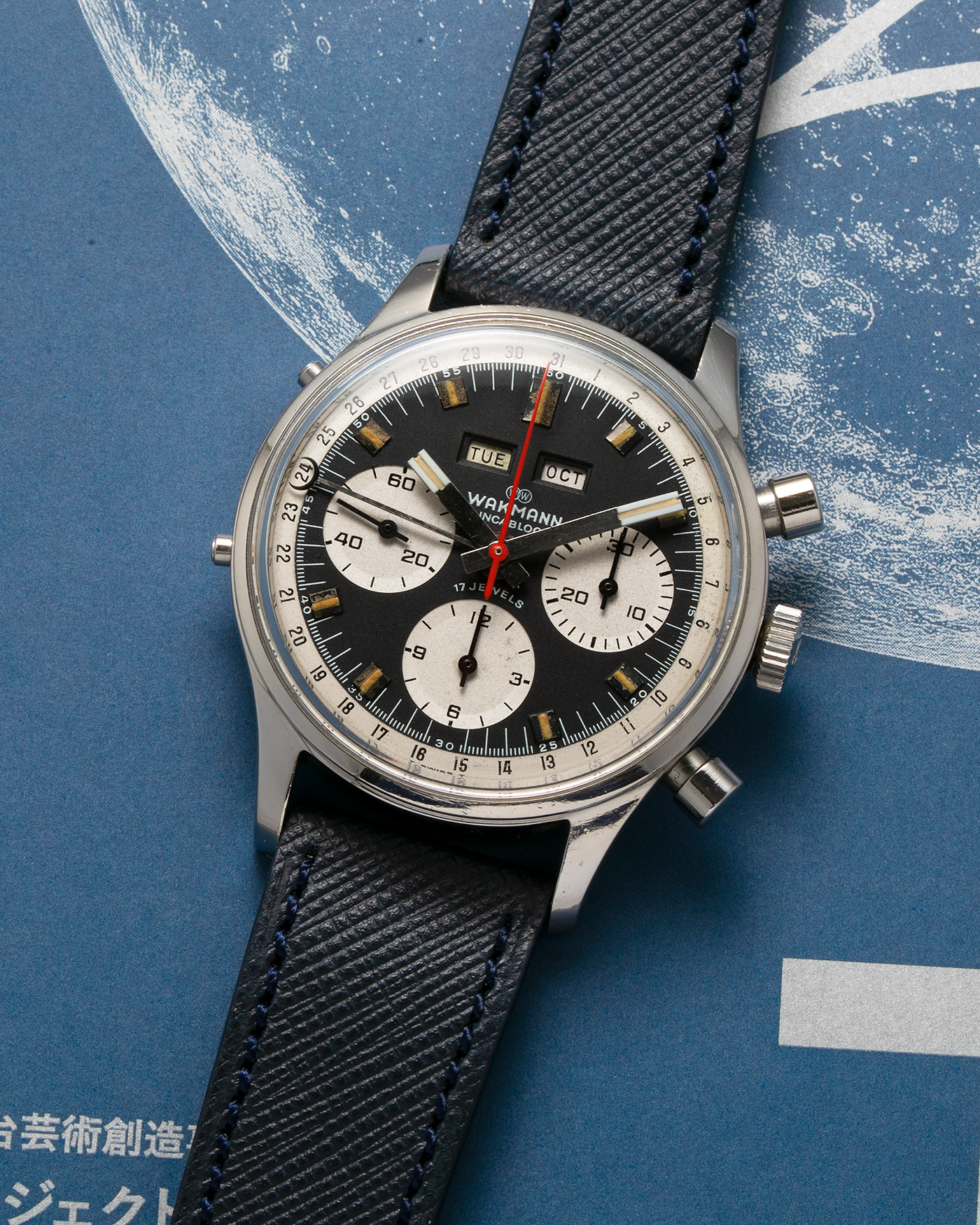 Brand: Wakmann Year: 1970’s Model: Triple Calendar Chronograph Reference Number: 71.1309.70 Material: Stainless Steel Movement: Valjoux Cal. 723, Manual-Winding Case Diameter: 37mm Lug Width: 20mm Strap: Molequin Navy Blue Textured Calf Leather Strap