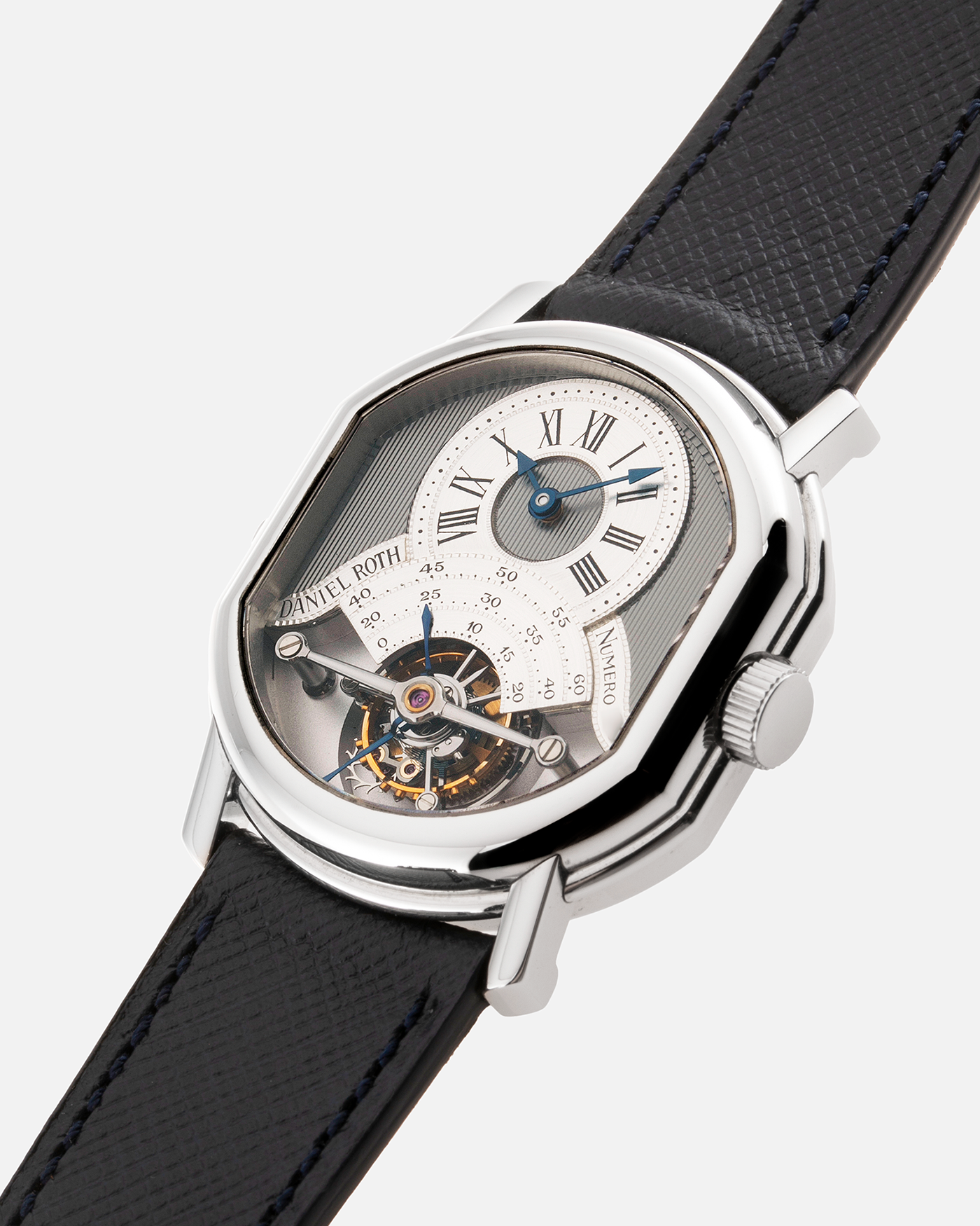 Brand: Daniel Roth Year: 1990’s Model: 2187 Material: Stainless Steel Movement: Cal. DR 307 One-Minute Tourbillon Regulator Case Diameter: 35mm X 38mm Strap: Molequin Navy Blue Textured Calf and Stainless Steel Deployant Clasp
