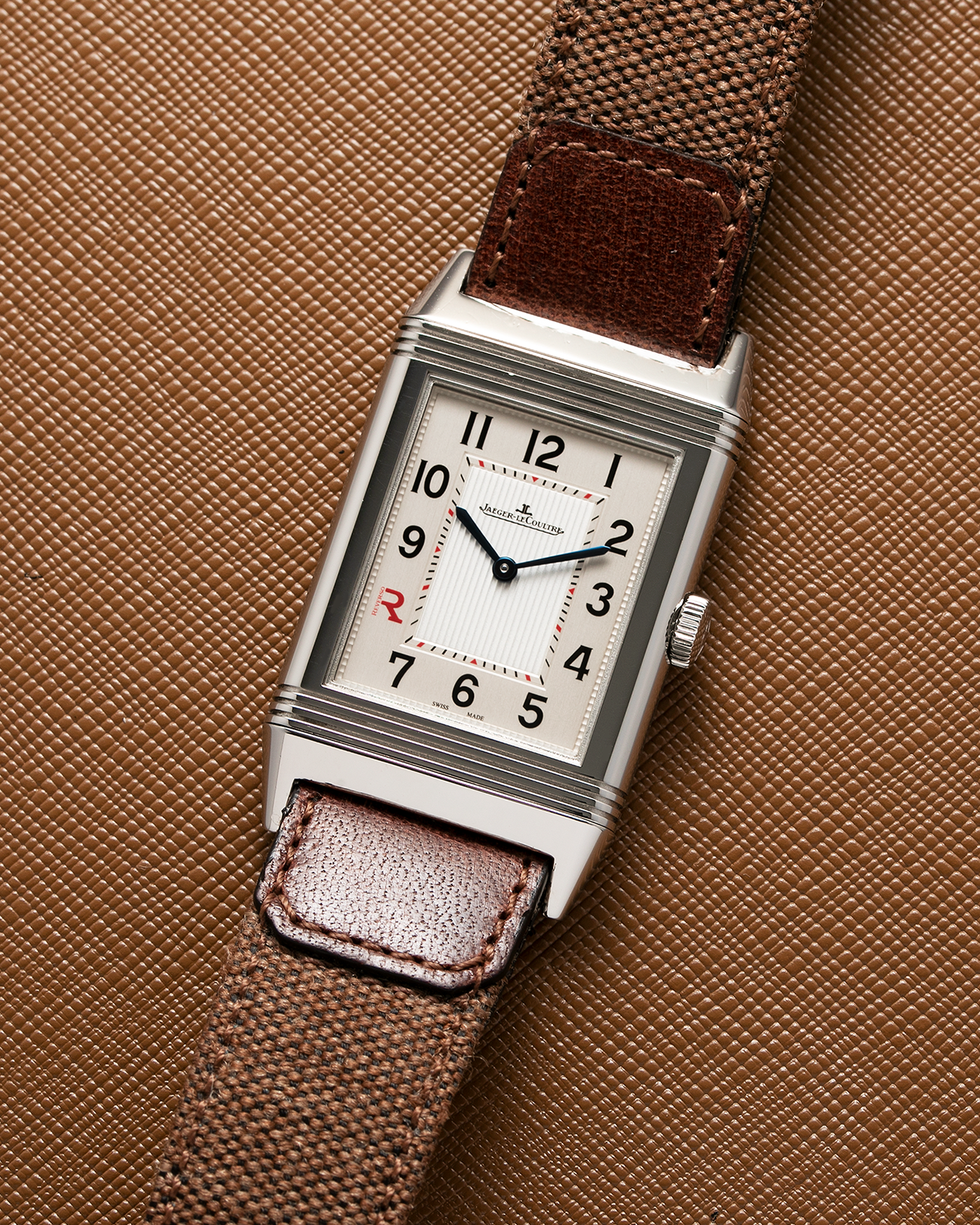 Brand: Jaeger LeCoultre Year: 2011 Model: Grande Reverso Ultra Thin Edizione Speciale Italica Ref 277.8.62 Material: Stainless Steel Movement: JLC Cal. 822, Manual-Wind Case Diameter: 46mm x 27mm Bracelet/Strap: Jaeger LeCoultre Case Fagliomo Brown Canvas Strap with Signed Tang Buckle