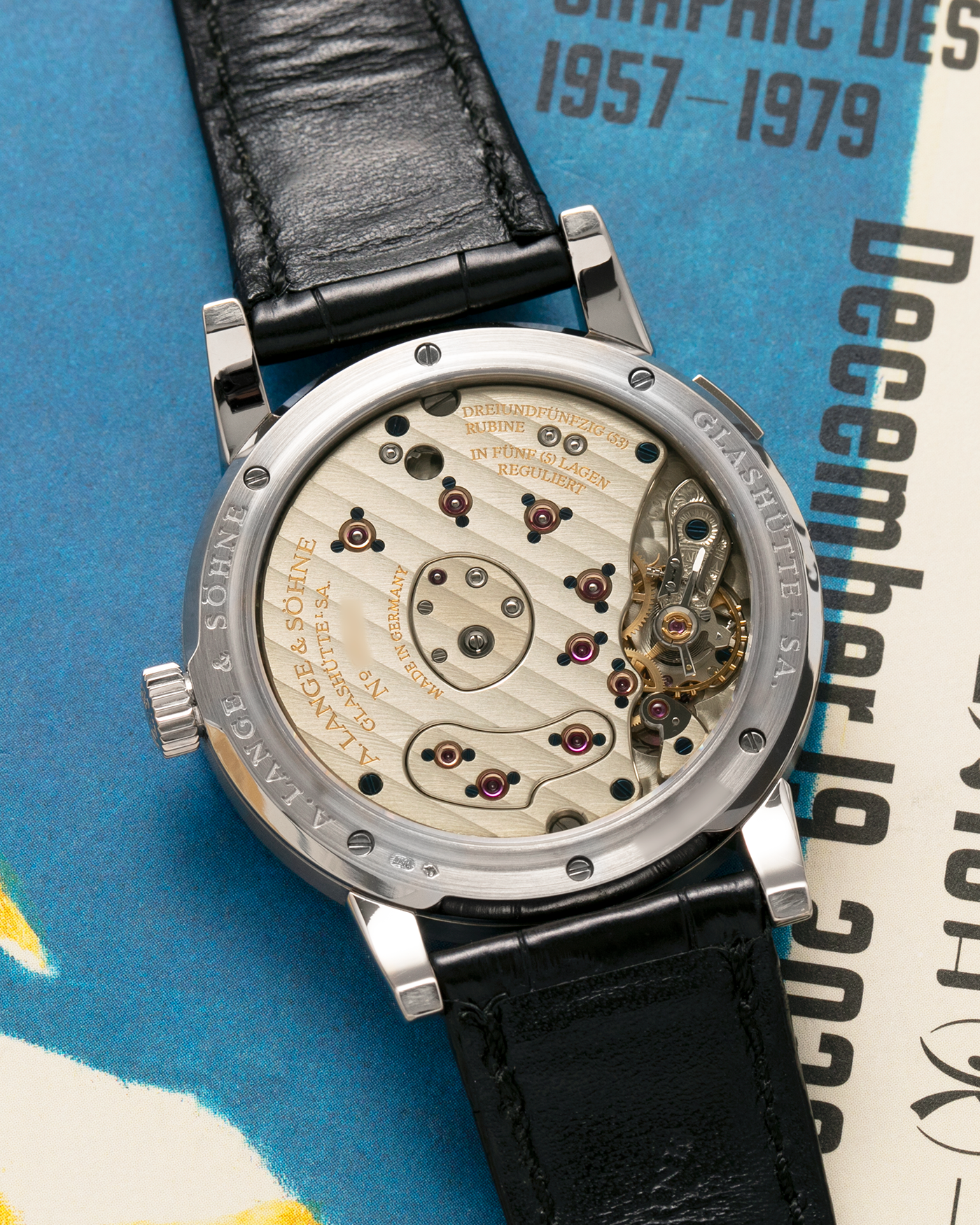 Brand: A. Lange & Söhne
Year: 2000’s
Model: Lange 1
Reference Number: 101.027
Material: 18-carat White Gold
Movement: A. Lange & Söhne Cal. L901.0, Manual Winding
Case Dimensions: 38.5mm x 9.5mm (Lug-to-Lug 47mm)
Lug Width: 20mm
Strap: A. Lange & Söhne Black Alligator Leather Strap with Signed 18-carat White Gold Tang Buckle