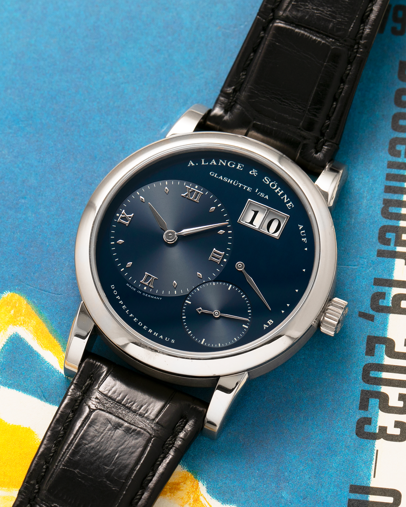 Brand: A. Lange & Söhne
Year: 2000’s
Model: Lange 1
Reference Number: 101.027
Material: 18-carat White Gold
Movement: A. Lange & Söhne Cal. L901.0, Manual Winding
Case Dimensions: 38.5mm x 9.5mm (Lug-to-Lug 47mm)
Lug Width: 20mm
Strap: A. Lange & Söhne Black Alligator Leather Strap with Signed 18-carat White Gold Tang Buckle