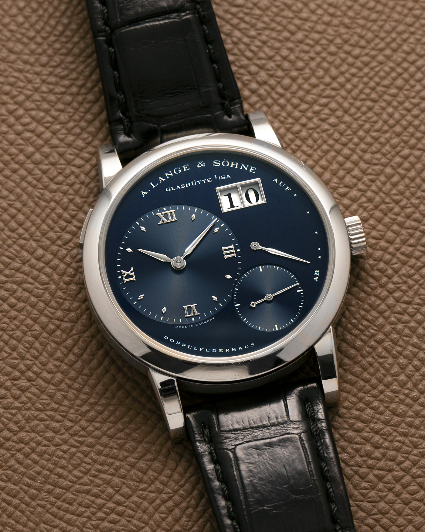 Brand: A. Lange & Söhne
Year: 2000’s
Model: Lange 1
Reference Number: 101.027
Material: 18-carat White Gold
Movement: A. Lange & Söhne Cal. L901.0, Manual Winding
Case Dimensions: 38.5mm x 9.5mm (Lug-to-Lug 47mm)
Lug Width: 20mm
Strap: A. Lange & Söhne Black Alligator Leather Strap with Signed 18-carat White Gold Tang Buckle