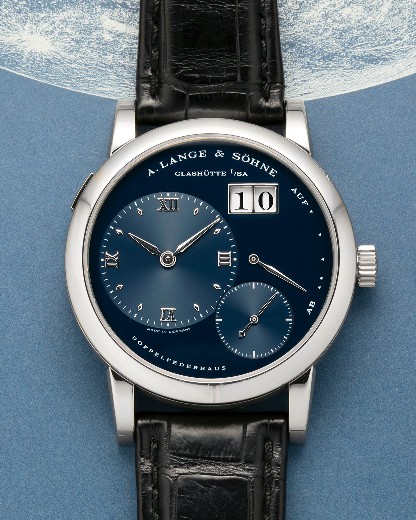Brand: A. Lange & Söhne
Year: 2000’s
Model: Lange 1
Reference Number: 101.027
Material: 18-carat White Gold
Movement: A. Lange & Söhne Cal. L901.0, Manual Winding
Case Dimensions: 38.5mm x 9.5mm (Lug-to-Lug 47mm)
Lug Width: 20mm
Strap: A. Lange & Söhne Black Alligator Leather Strap with Signed 18-carat White Gold Tang Buckle