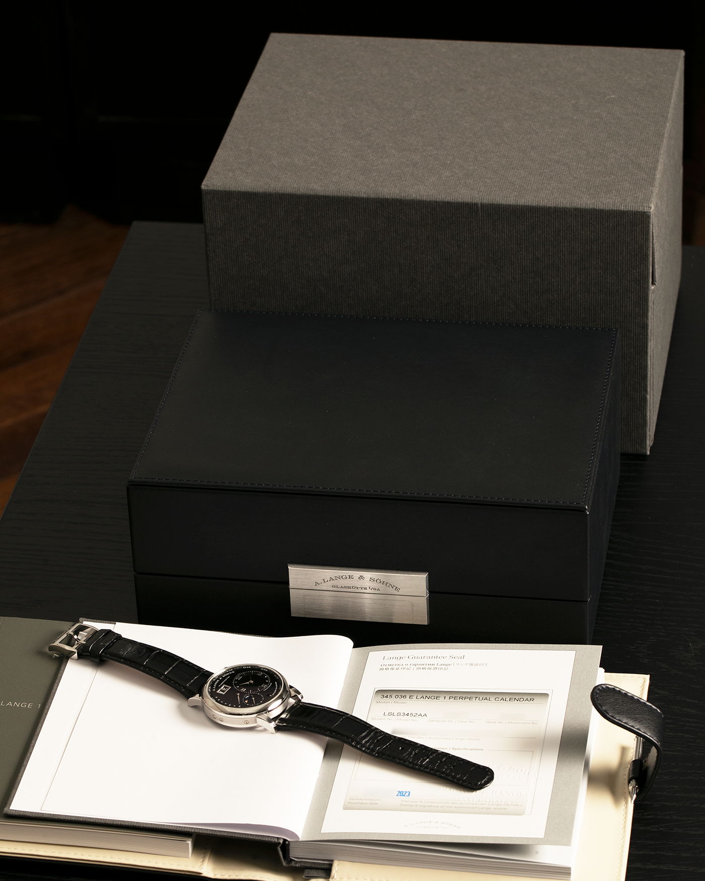 Brand: A. Lange & Söhne
Year: 2023
Model: Lange 1 Perpetual Calendar ‘Darth’
Reference Number: 345.036 E
Material: Platinum 950
Movement: A. Lange & Söhne Cal. L021.3, Self-Winding
Case Dimensions: 41.9mm x 12.1mm (Lug-to-Lug 50mm)
Lug Width: 22mm
Strap: A. Lange & Söhne Black Alligator Leather Strap with Signed Platinum 950 Tang Buckle
