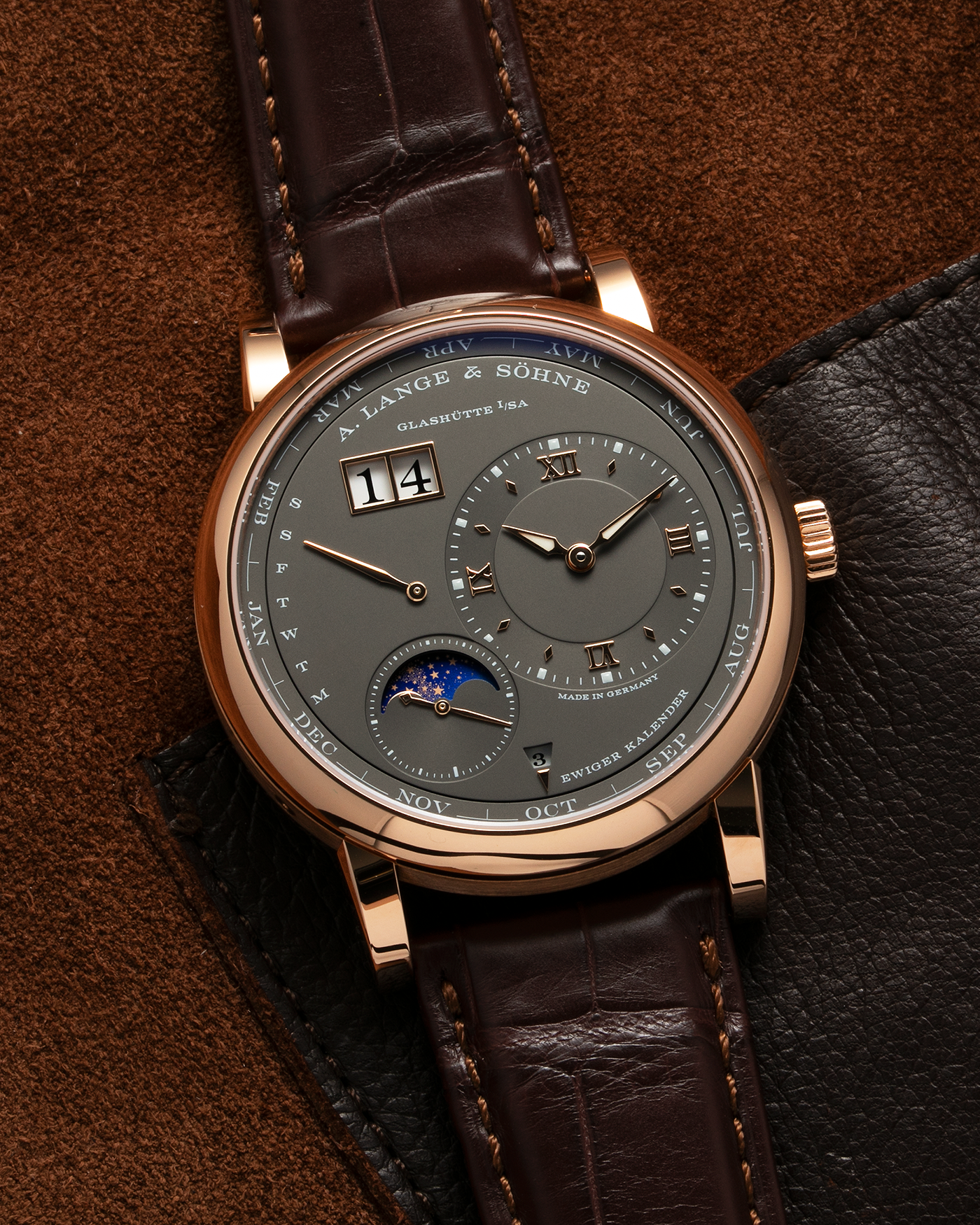 Brand: A. Lange & Söhne Year: 2022 Model: Lange 1 Perpetual Calendar Reference Number: 345.033 E Material: 18-carat Rose Gold Case Movement: A. Lange & Söhne Cal. L021.3, Self-Winding Case Dimensions: 41.9mm x 12.1mm Lug Width: 22mm Strap: A. Lange & Söhne Dark Brown Alligator Strap with 18-carat Rose Gold Tang Buckle, and additional Generic Grey Nubuck Stitched Leather Strap