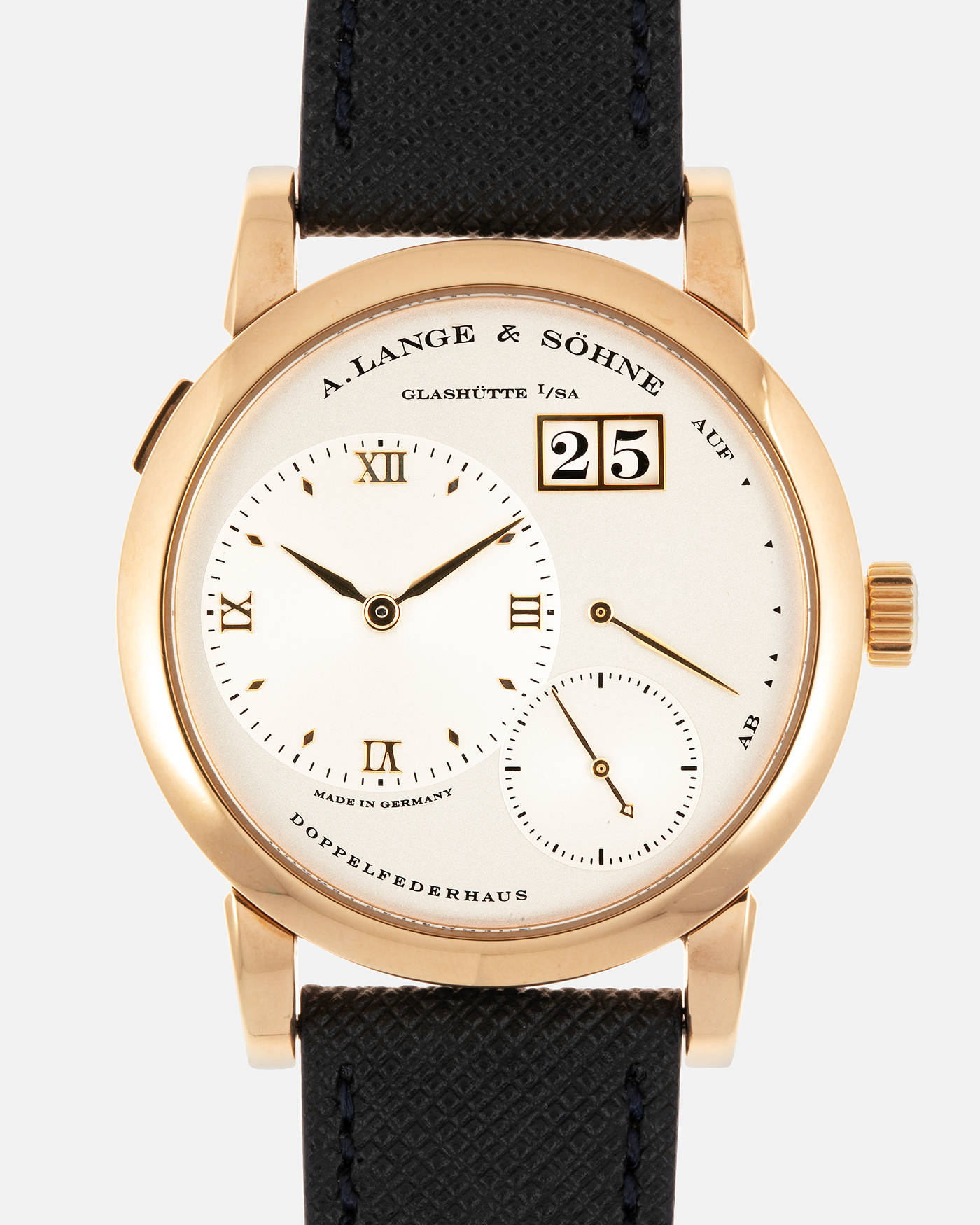 Brand: A. Lange & Sohne Year: 2000s Model: Lange 1 Reference: 101.032 Material: 18-carat Rose Gold, German Silver Movement: A. Lange & Söhne Cal. L901.0, Manual-Winding Case Diameter: 38.5mm Lug Width: 20mm Strap: Molequin Navy Blue Textured Calf Leather Strap with Signed 18-carat Rose Gold Tang Buckle, with additional A. Lange & Söhne Black Alligator Leather Strap (Used)