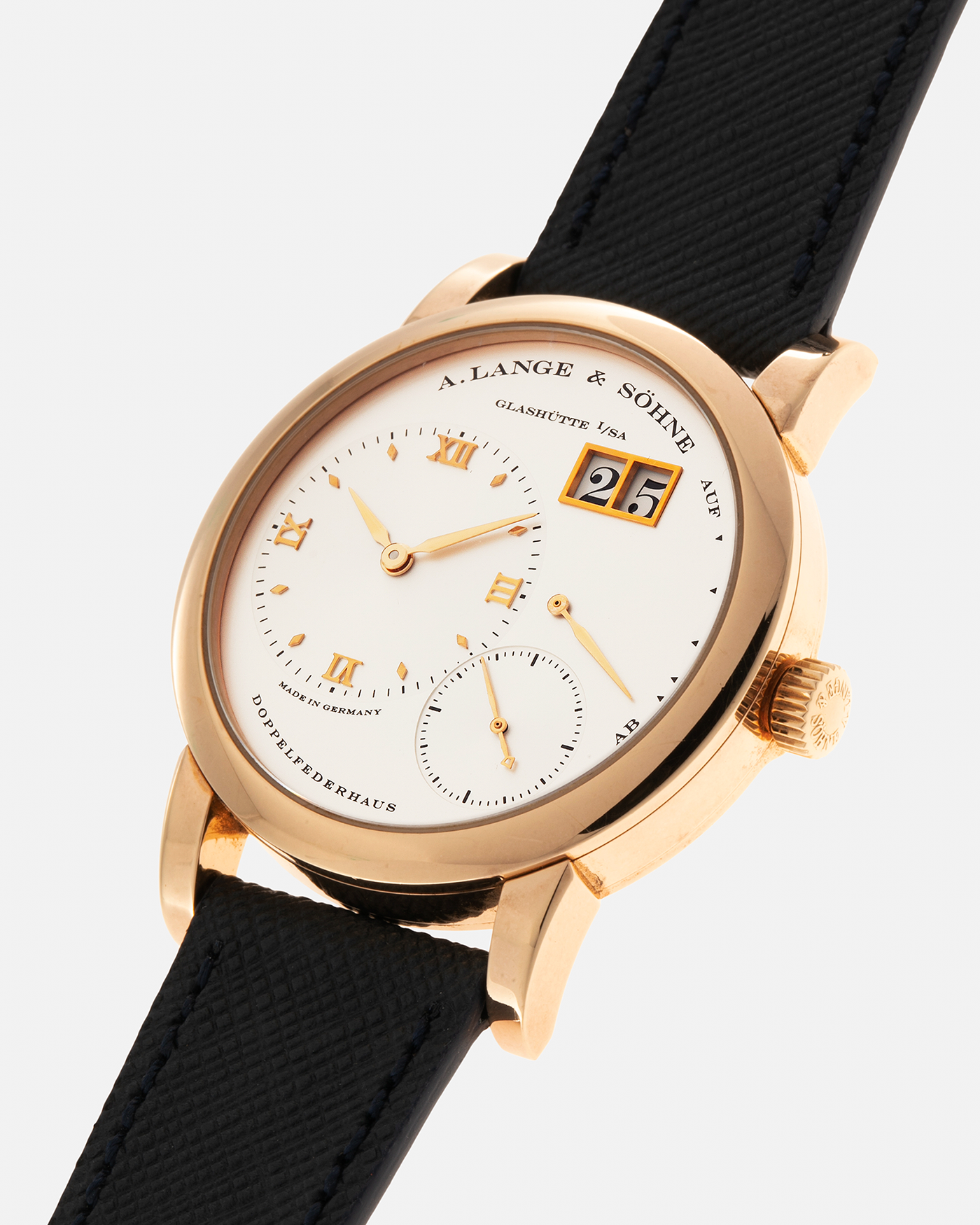 Brand: A. Lange & Sohne Year: 2000s Model: Lange 1 Reference: 101.032 Material: 18-carat Rose Gold, German Silver Movement: A. Lange & Söhne Cal. L901.0, Manual-Winding Case Diameter: 38.5mm Lug Width: 20mm Strap: Molequin Navy Blue Textured Calf Leather Strap with Signed 18-carat Rose Gold Tang Buckle, with additional A. Lange & Söhne Black Alligator Leather Strap (Used)