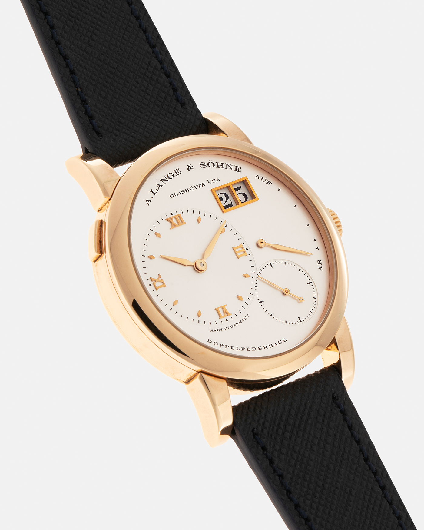 Brand: A. Lange & Sohne Year: 2000s Model: Lange 1 Reference: 101.032 Material: 18-carat Rose Gold, German Silver Movement: A. Lange & Söhne Cal. L901.0, Manual-Winding Case Diameter: 38.5mm Lug Width: 20mm Strap: Molequin Navy Blue Textured Calf Leather Strap with Signed 18-carat Rose Gold Tang Buckle, with additional A. Lange & Söhne Black Alligator Leather Strap (Used)