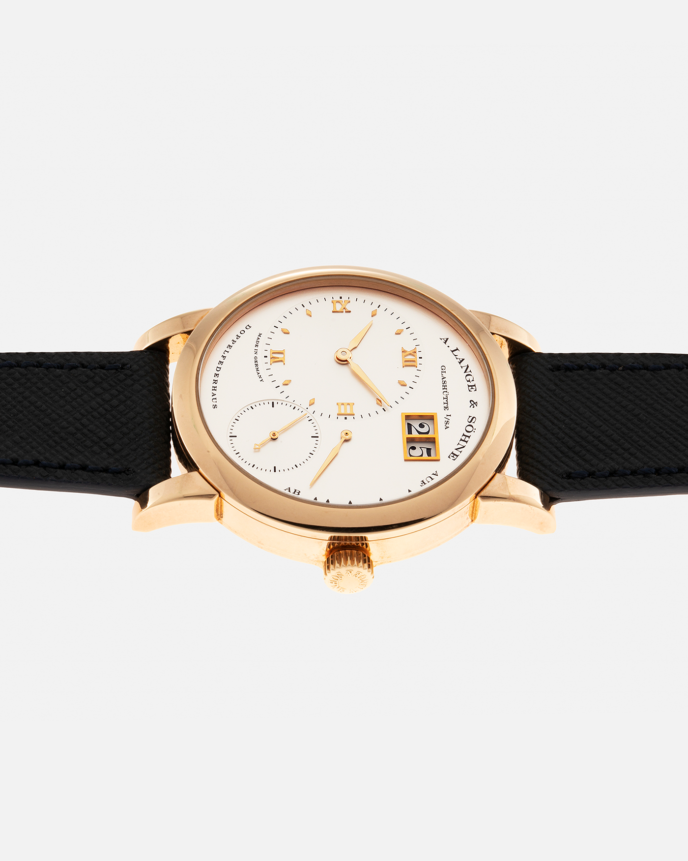 Brand: A. Lange & Sohne Year: 2000s Model: Lange 1 Reference: 101.032 Material: 18-carat Rose Gold, German Silver Movement: A. Lange & Söhne Cal. L901.0, Manual-Winding Case Diameter: 38.5mm Lug Width: 20mm Strap: Molequin Navy Blue Textured Calf Leather Strap with Signed 18-carat Rose Gold Tang Buckle, with additional A. Lange & Söhne Black Alligator Leather Strap (Used)
