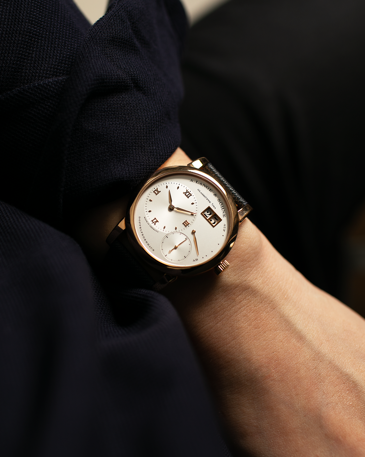 Brand: A. Lange & Sohne Year: 2000s Model: Lange 1 Reference: 101.032 Material: 18-carat Rose Gold, German Silver Movement: A. Lange & Söhne Cal. L901.0, Manual-Winding Case Diameter: 38.5mm Lug Width: 20mm Strap: Molequin Navy Blue Textured Calf Leather Strap with Signed 18-carat Rose Gold Tang Buckle, with additional A. Lange & Söhne Black Alligator Leather Strap (Used)