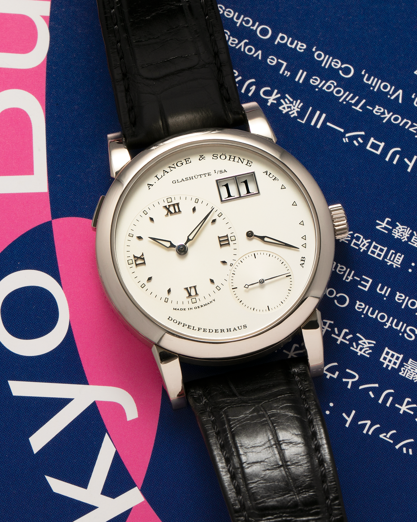 Brand: A. Lange & Söhne
Year: 2010s
Model: Lange 1
Reference: 101.039
Material: 18-carat White Gold
Movement: A. Lange & Söhne Cal. L901.0, Manual-Winding
Case Dimensions: 38.5mm x 9.8mm (Lug-to-Lug 47.3mm)
Lug Width: 20mm
Strap: A. Lange & Söhne Black Alligator Leather Strap with Signed 18-carat White Gold Tang Buckle