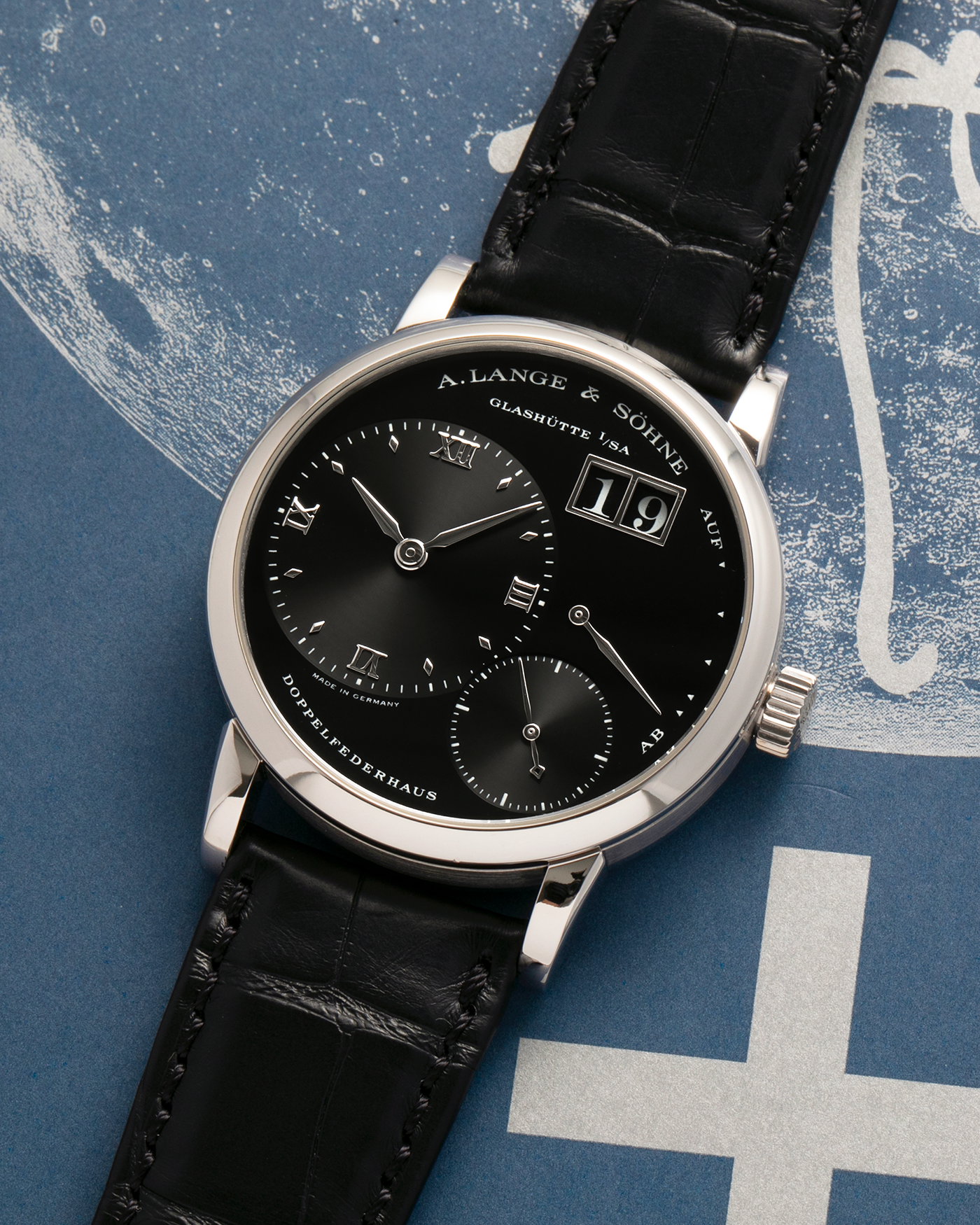 Brand: A. Lange & Söhne
Year: 2005
Model: Little Lange 1 ‘Darth’
Reference: 111.035
Material: Platinum 950
Movement: A. Lange & Söhne Cal. L901.0, Manual Winding
Case Dimensions: 36mm x 10mm (Lug-to-Lug 43mm)
Lug Width: 19mm
Strap: A. Lange & Söhne Black Alligator Leather Strap with Signed Platinum 950 Tang Buckle