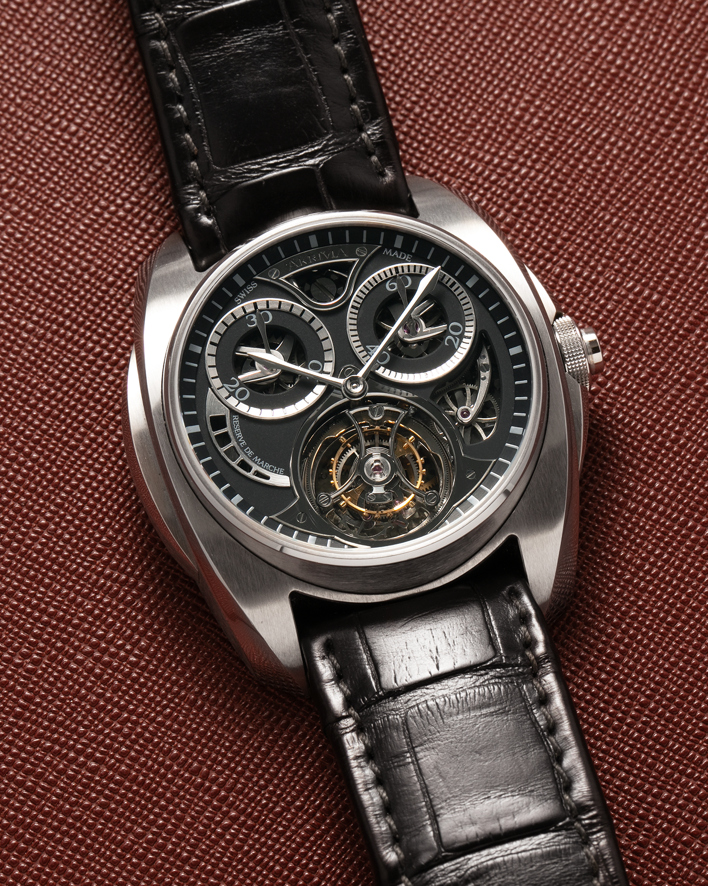 Brand: Akrivia Year: 2016 Model: Tourbillon Chronographe Monopoussoir AK-01 Material: Titanium Movement: Akrivia Cal. AK-01, Manual-Winding Case Dimensions: 42.5mm x 12.9mm (Lug-to-Lug 50mm) Lug Width: 21mm Strap: Akrivia Black Textured Calf Leather Strap with Signed Titanium Tang Buckle