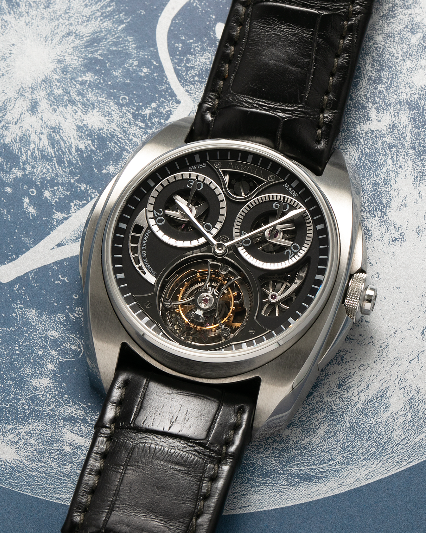 Brand: Akrivia Year: 2016 Model: Tourbillon Chronographe Monopoussoir AK-01 Material: Titanium Movement: Akrivia Cal. AK-01, Manual-Winding Case Dimensions: 42.5mm x 12.9mm (Lug-to-Lug 50mm) Lug Width: 21mm Strap: Akrivia Black Textured Calf Leather Strap with Signed Titanium Tang Buckle