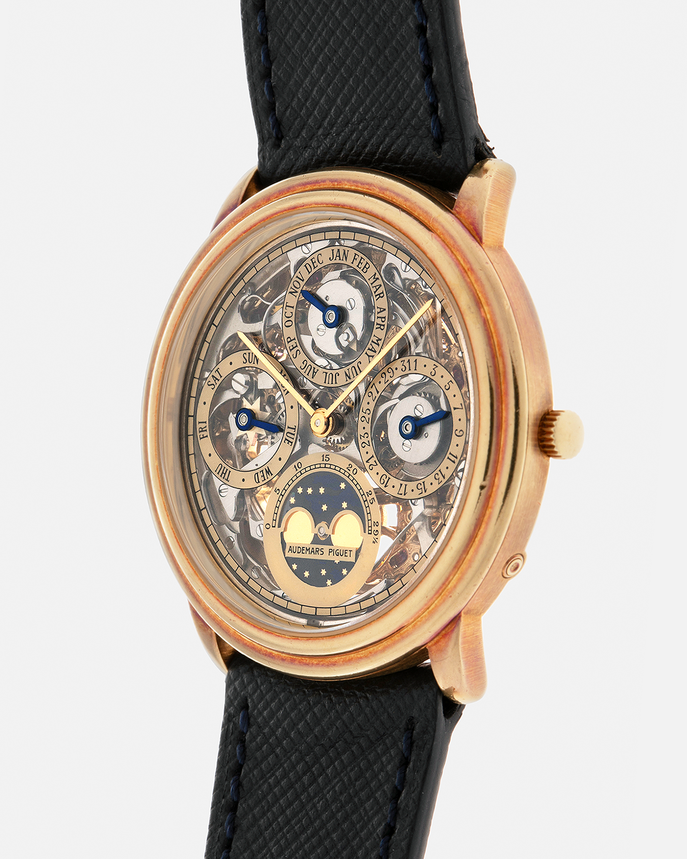 Brand: Audemars Piguet
Year: 1980’s
Model: Quantieme Perpetual Calendar Openworked
Reference Number: 25668BA
Material: 18-carat Yellow Gold
Movement: Audemars Piguet Cal. 2120/2800, Self-Winding
Case Dimensions: 36mm x 8mm (Lug-to-Lug 37mm)
Lug Width: 20mm
Strap: Molequin Dark Navy Textured Calf Leather Strap with Signed 18-carat Yellow Gold Tang Buckle