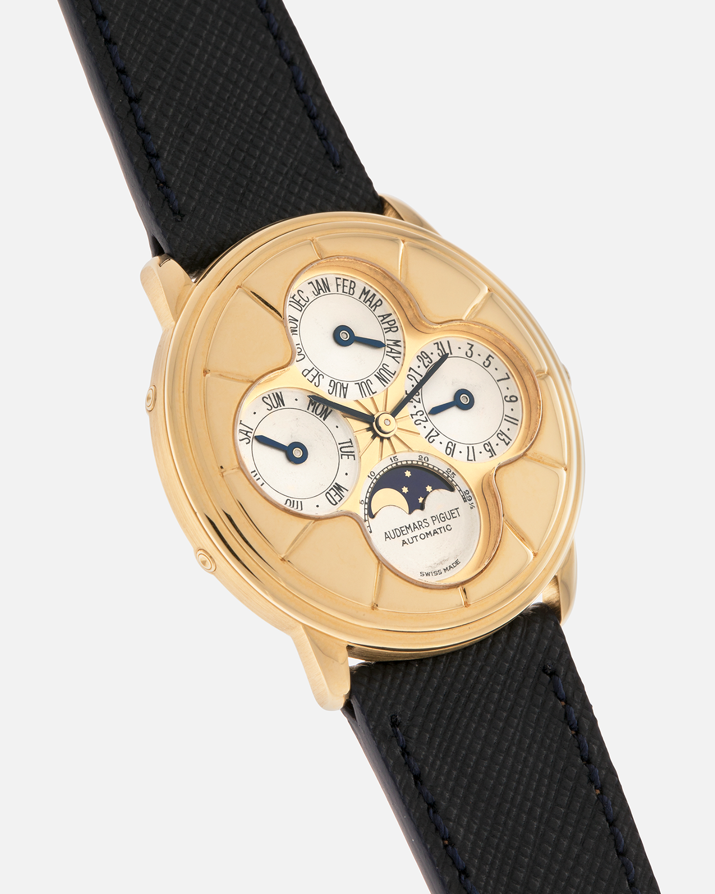 Brand: Audemars Piguet
Year: 1990s
Model: Quantième Perpetual Calendar ‘Clover’
Reference: 25681BA
Material: 18-carat Yellow Gold
Movement: Audemars Piguet Cal. 2120/2, Self-Winding
Case Dimensions: 36mm x 8mm (Lug-to-Lug 38.5mm)
Lug Width: 20mm
Straps: Molequin Dark Navy Textured Calf Leather Strap with 18k Yellow Gold Audemars Piguet Deployant Clasp