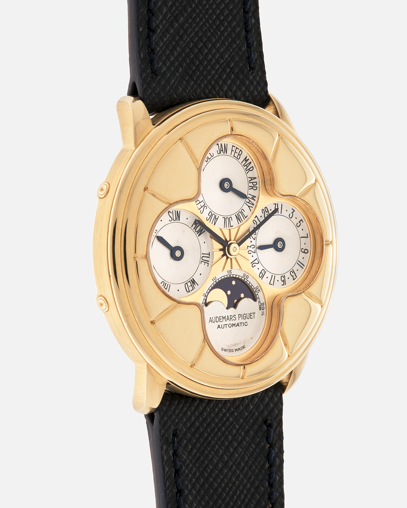 Brand: Audemars Piguet
Year: 1990s
Model: Quantième Perpetual Calendar ‘Clover’
Reference: 25681BA
Material: 18-carat Yellow Gold
Movement: Audemars Piguet Cal. 2120/2, Self-Winding
Case Dimensions: 36mm x 8mm (Lug-to-Lug 38.5mm)
Lug Width: 20mm
Straps: Molequin Dark Navy Textured Calf Leather Strap with 18k Yellow Gold Audemars Piguet Deployant Clasp