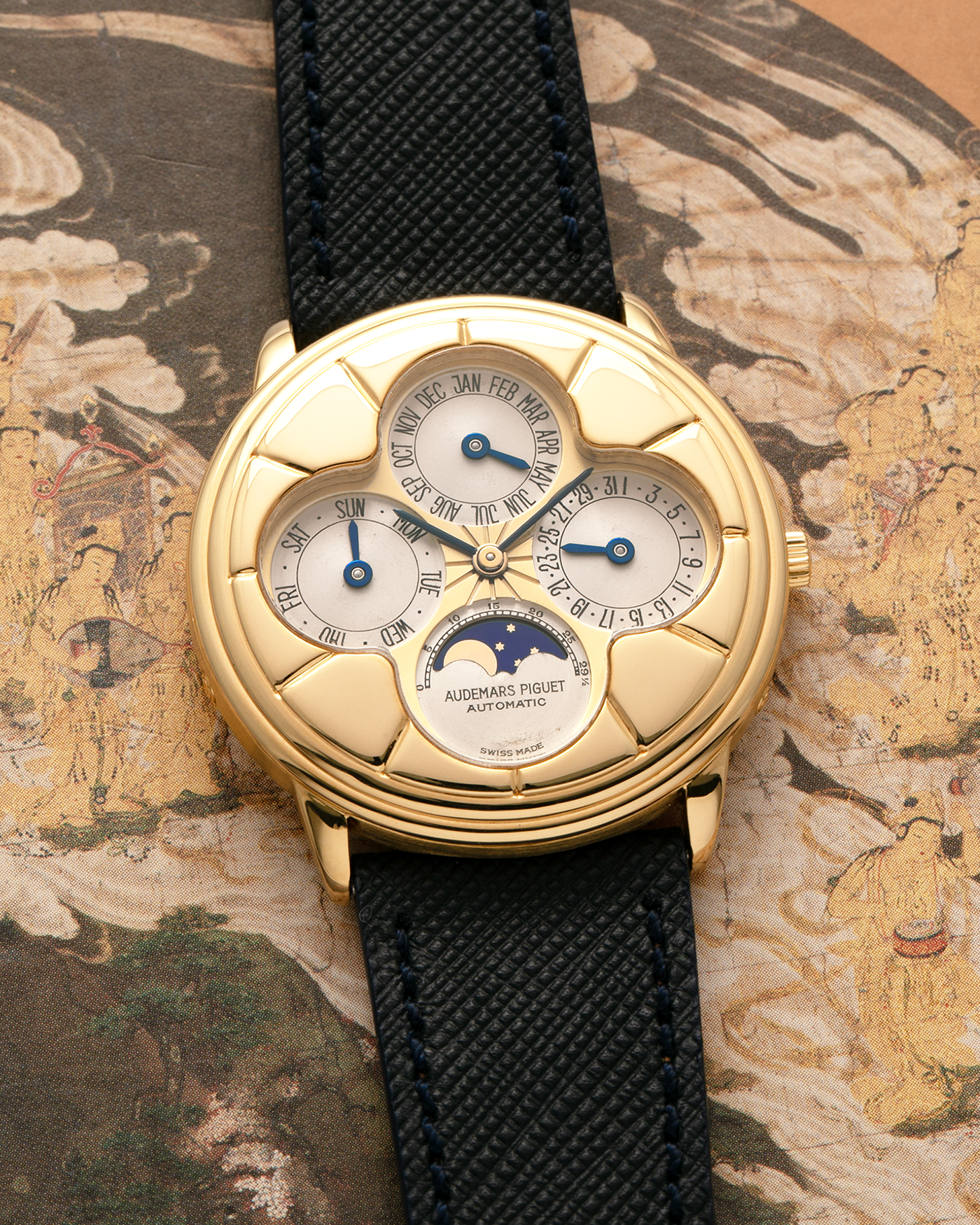 Brand: Audemars Piguet
Year: 1990s
Model: Quantième Perpetual Calendar ‘Clover’
Reference: 25681BA
Material: 18-carat Yellow Gold
Movement: Audemars Piguet Cal. 2120/2, Self-Winding
Case Dimensions: 36mm x 8mm (Lug-to-Lug 38.5mm)
Lug Width: 20mm
Straps: Molequin Dark Navy Textured Calf Leather Strap with 18k Yellow Gold Audemars Piguet Deployant Clasp