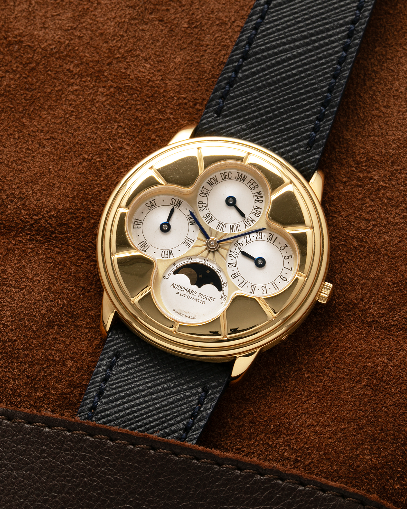 Brand: Audemars Piguet
Year: 1990s
Model: Quantième Perpetual Calendar ‘Clover’
Reference: 25681BA
Material: 18-carat Yellow Gold
Movement: Audemars Piguet Cal. 2120/2, Self-Winding
Case Dimensions: 36mm x 8mm (Lug-to-Lug 38.5mm)
Lug Width: 20mm
Straps: Molequin Dark Navy Textured Calf Leather Strap with 18k Yellow Gold Audemars Piguet Deployant Clasp