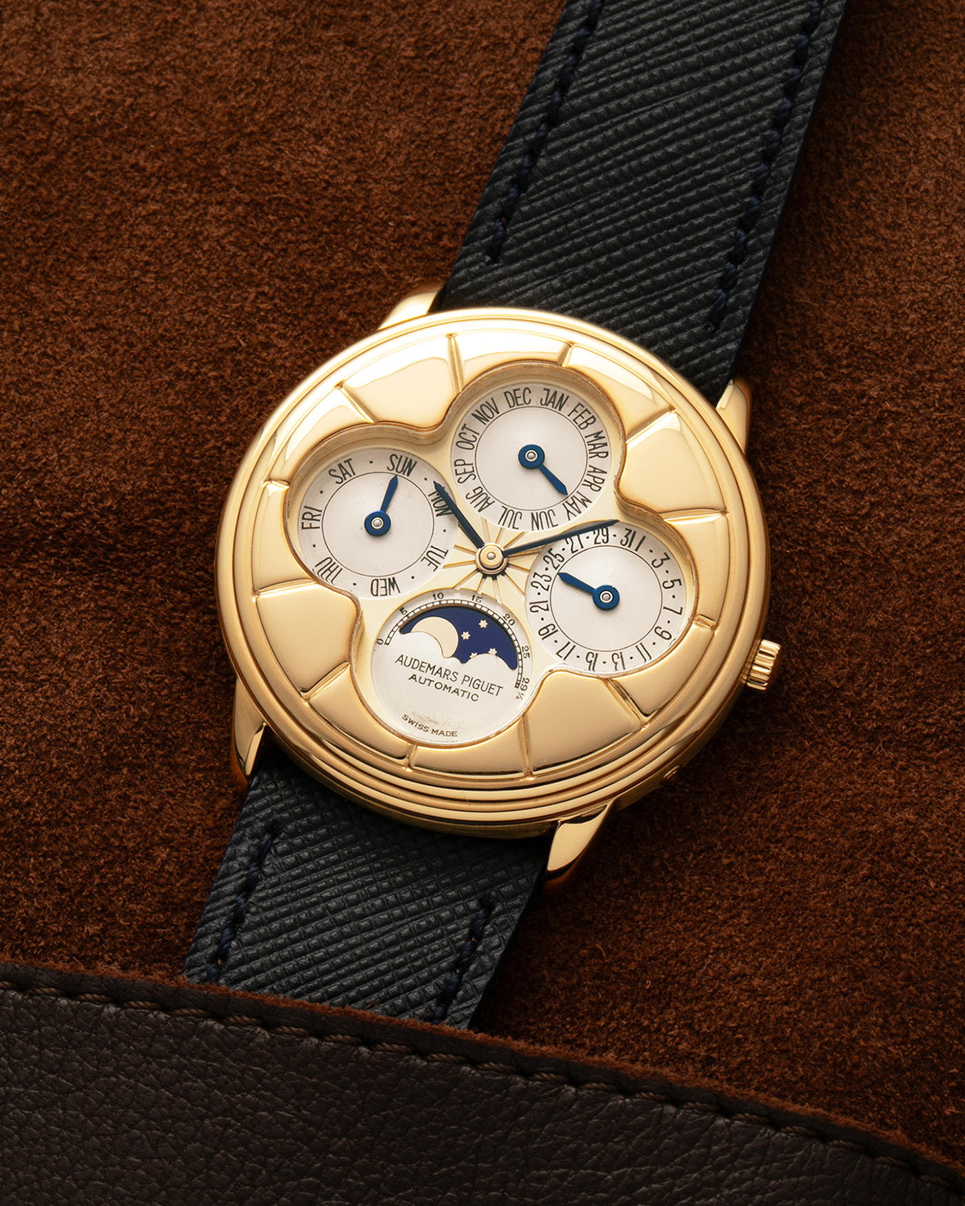 Brand: Audemars Piguet
Year: 1990s
Model: Quantième Perpetual Calendar ‘Clover’
Reference: 25681BA
Material: 18-carat Yellow Gold
Movement: Audemars Piguet Cal. 2120/2, Self-Winding
Case Dimensions: 36mm x 8mm (Lug-to-Lug 38.5mm)
Lug Width: 20mm
Straps: Molequin Dark Navy Textured Calf Leather Strap with 18k Yellow Gold Audemars Piguet Deployant Clasp