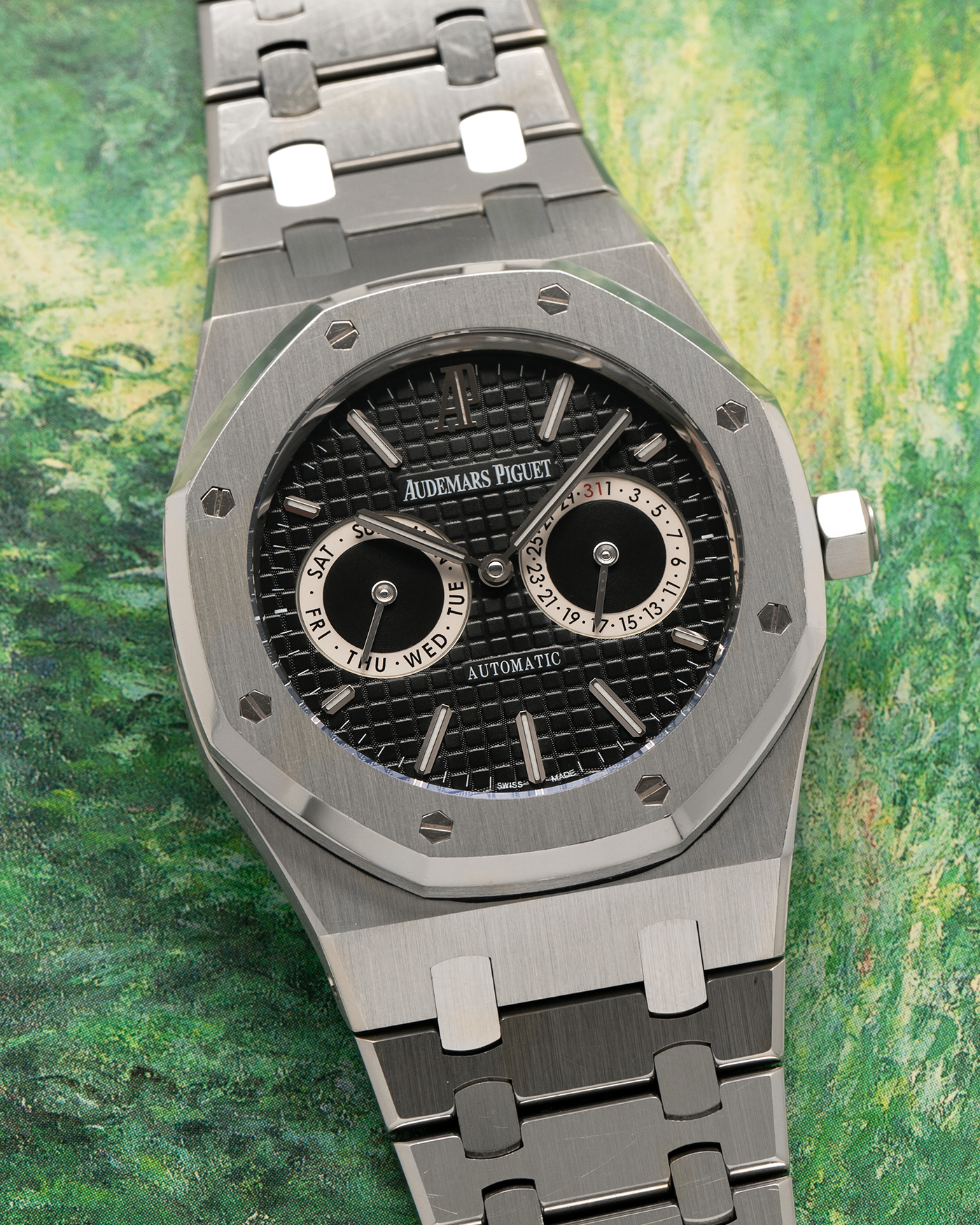 Brand: Audemars Piguet
Year: 2012
Model: Royal Oak Day Date
Reference: 26330ST.OO.1220ST.01.A
Material: Stainless Steel
Movement: Audemars Piguet Cal 2324/2810 (Derived from JLC Cal. 889), Self-Winding
Case Dimensions: 39mm x 10.5 (Lug-to-Lug 49mm)
Bracelet: Audemars Piguet Stainless Steel Integrated Bracelet