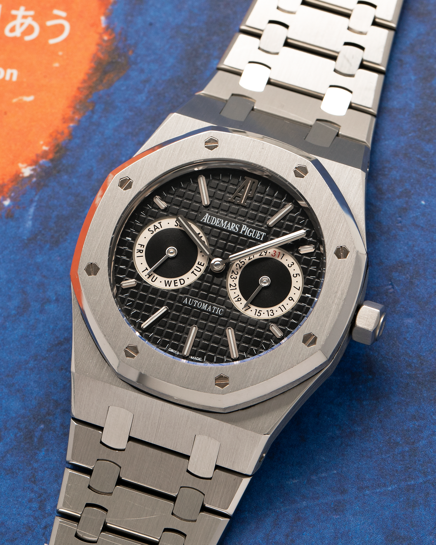 Brand: Audemars Piguet
Year: 2012
Model: Royal Oak Day Date
Reference: 26330ST.OO.1220ST.01.A
Material: Stainless Steel
Movement: Audemars Piguet Cal 2324/2810 (Derived from JLC Cal. 889), Self-Winding
Case Dimensions: 39mm x 10.5 (Lug-to-Lug 49mm)
Bracelet: Audemars Piguet Stainless Steel Integrated Bracelet