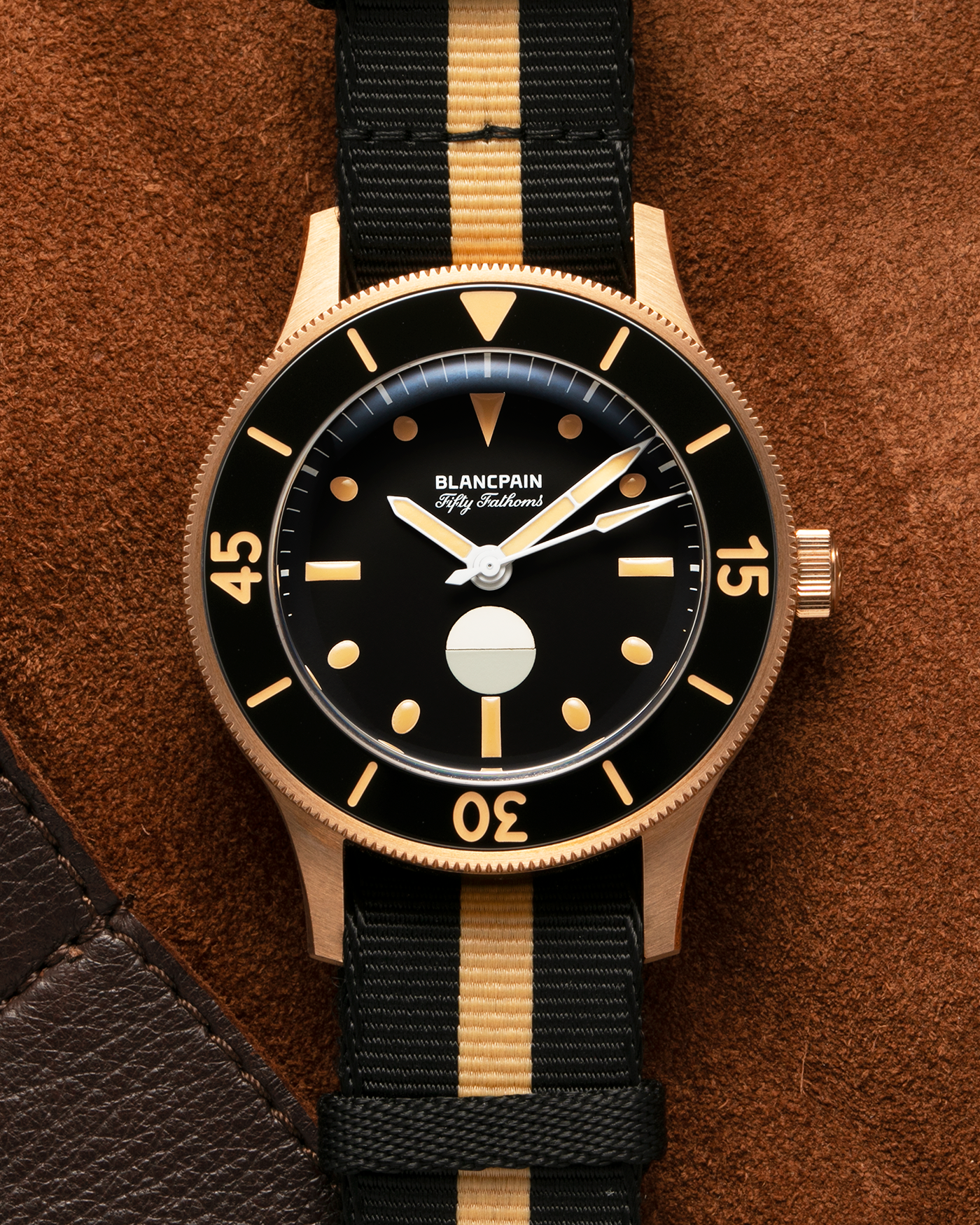 Brand: Blancpain
Year: 2024
Model: Fifty Fathoms 70th Anniversary Act 3, Limited Edition of 555 Pieces
Reference Number: 5901-5630 NANA
Material: 9-carat Bronze Gold, Black Ceramic Bezel Insert
Movement: Blancpain Cal. 1154.P2 (Derived from Blancpain Cal. 1150), Self-Winding
Case Dimensions: 41.3mm x 13.3mm (Lug-to-Lug 41.3mm)
Lug Width: 20mm
Strap: Blancpain Two-Tone NATO Strap with Signed 9-carat Bronze Gold Tang Buckle
