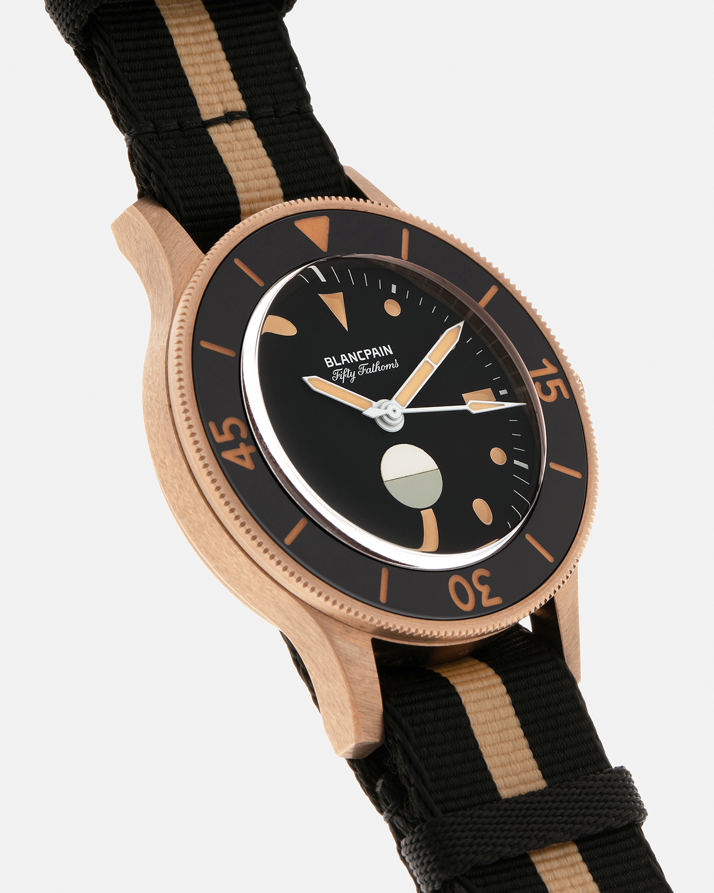 Brand: Blancpain
Year: 2024
Model: Fifty Fathoms 70th Anniversary Act 3, Limited Edition of 555 Pieces
Reference Number: 5901-5630 NANA
Material: 9-carat Bronze Gold, Black Ceramic Bezel Insert
Movement: Blancpain Cal. 1154.P2 (Derived from Blancpain Cal. 1150), Self-Winding
Case Dimensions: 41.3mm x 13.3mm (Lug-to-Lug 41.3mm)
Lug Width: 20mm
Strap: Blancpain Two-Tone NATO Strap with Signed 9-carat Bronze Gold Tang Buckle