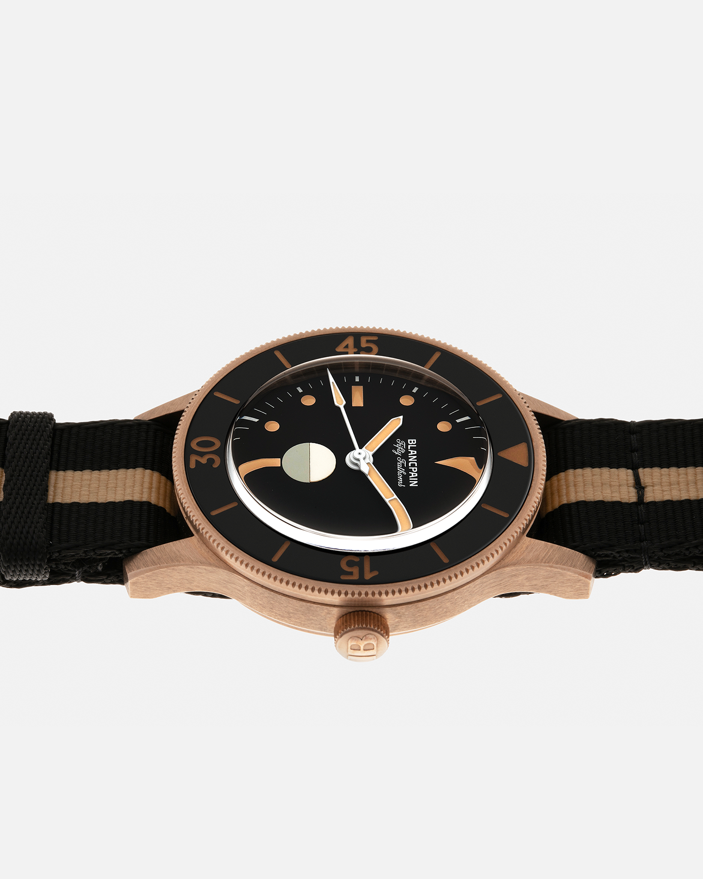 Brand: Blancpain
Year: 2024
Model: Fifty Fathoms 70th Anniversary Act 3, Limited Edition of 555 Pieces
Reference Number: 5901-5630 NANA
Material: 9-carat Bronze Gold, Black Ceramic Bezel Insert
Movement: Blancpain Cal. 1154.P2 (Derived from Blancpain Cal. 1150), Self-Winding
Case Dimensions: 41.3mm x 13.3mm (Lug-to-Lug 41.3mm)
Lug Width: 20mm
Strap: Blancpain Two-Tone NATO Strap with Signed 9-carat Bronze Gold Tang Buckle