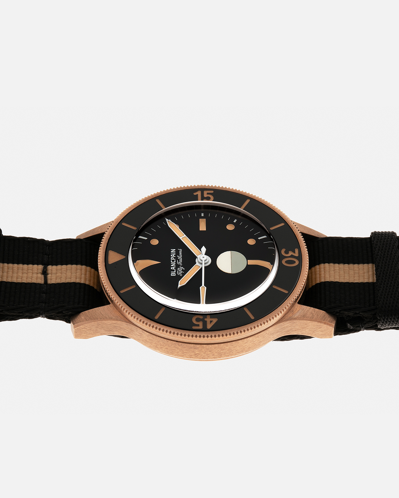 Brand: Blancpain
Year: 2024
Model: Fifty Fathoms 70th Anniversary Act 3, Limited Edition of 555 Pieces
Reference Number: 5901-5630 NANA
Material: 9-carat Bronze Gold, Black Ceramic Bezel Insert
Movement: Blancpain Cal. 1154.P2 (Derived from Blancpain Cal. 1150), Self-Winding
Case Dimensions: 41.3mm x 13.3mm (Lug-to-Lug 41.3mm)
Lug Width: 20mm
Strap: Blancpain Two-Tone NATO Strap with Signed 9-carat Bronze Gold Tang Buckle