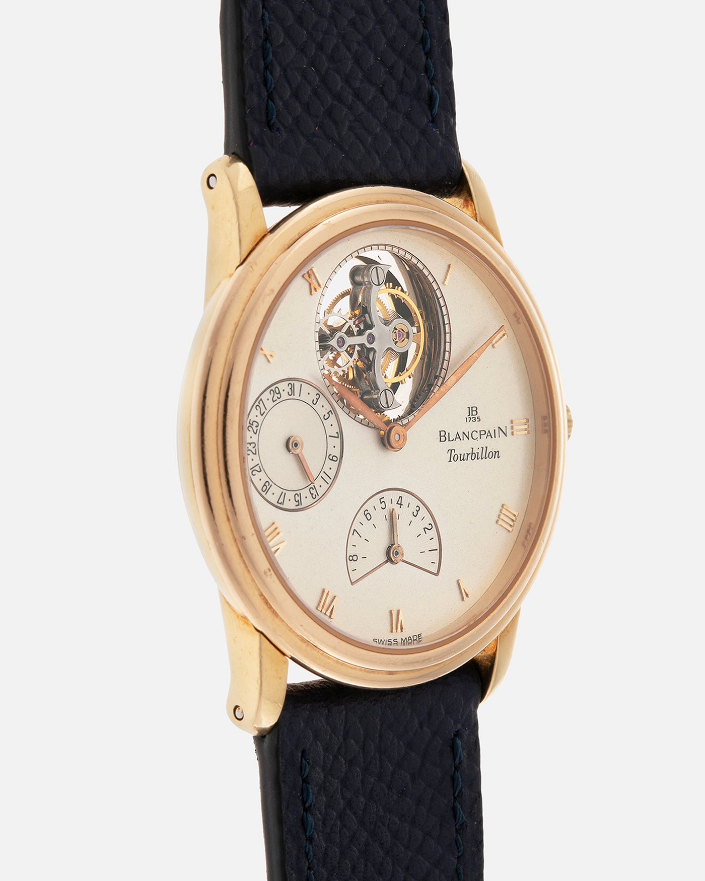 Brand: Blancpain
Year: 1996
Model: Villeret Flying Tourbillon 8 Days, Limited to 99 Pieces Across all Metals
Reference: 0023-1418-55
Material: 18-carat Yellow Gold
Movement: Blancpain Cal. 23, Manual-Winding Flying Tourbillon
Case Dimensions: 34mm x 7.4mm (Lug-to-Lug 40mm)
Lug Width: 19mm
Strap: Nostime Dark Navy Textured Calf Leather Strap with Signed 18-carat Tang Buckle, with extra used Blancpain Black Alligator Leather Strap