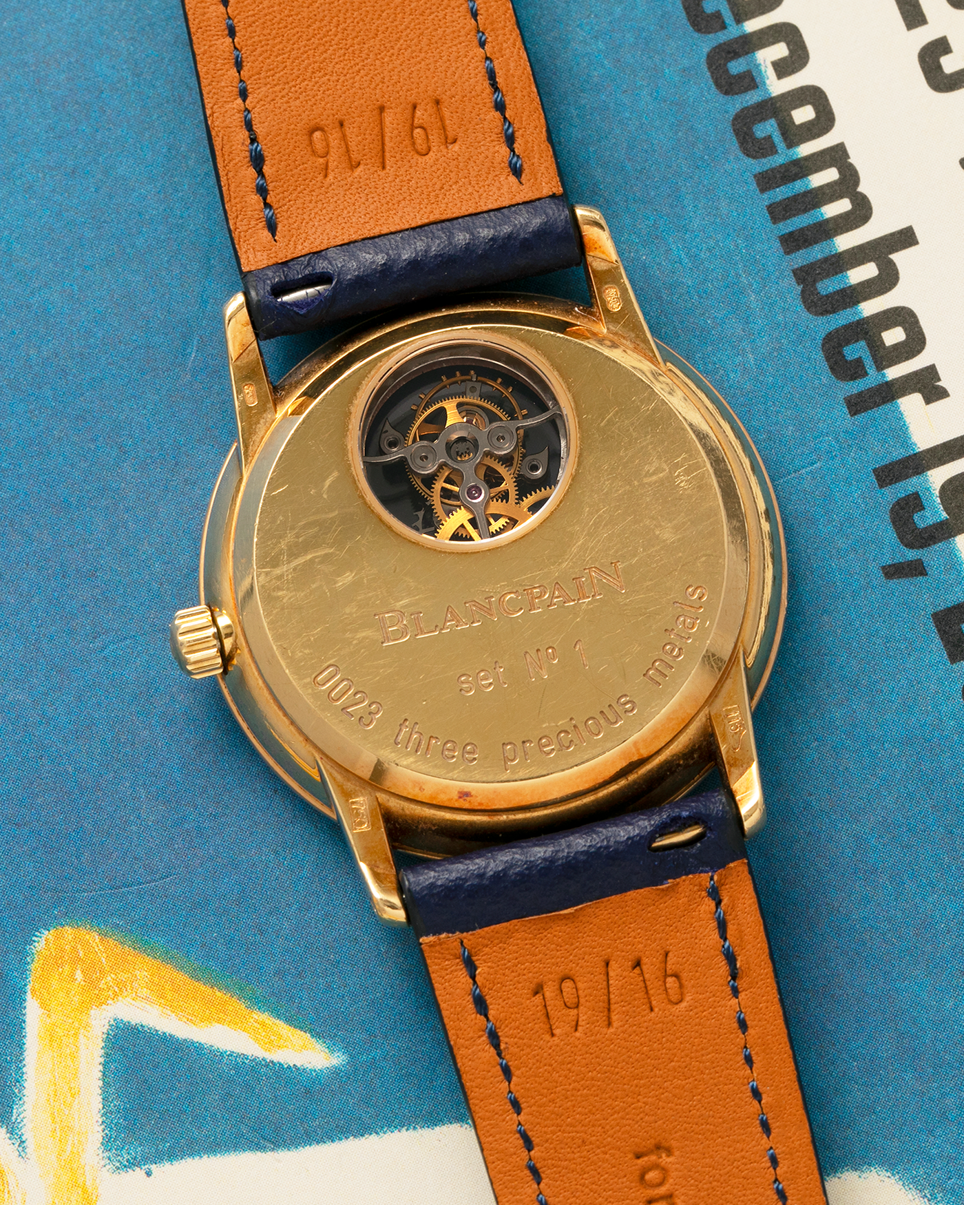 Brand: Blancpain
Year: 1996
Model: Villeret Flying Tourbillon 8 Days, Limited to 99 Pieces Across all Metals
Reference: 0023-1418-55
Material: 18-carat Yellow Gold
Movement: Blancpain Cal. 23, Manual-Winding Flying Tourbillon
Case Dimensions: 34mm x 7.4mm (Lug-to-Lug 40mm)
Lug Width: 19mm
Strap: Nostime Dark Navy Textured Calf Leather Strap with Signed 18-carat Tang Buckle, with extra used Blancpain Black Alligator Leather Strap