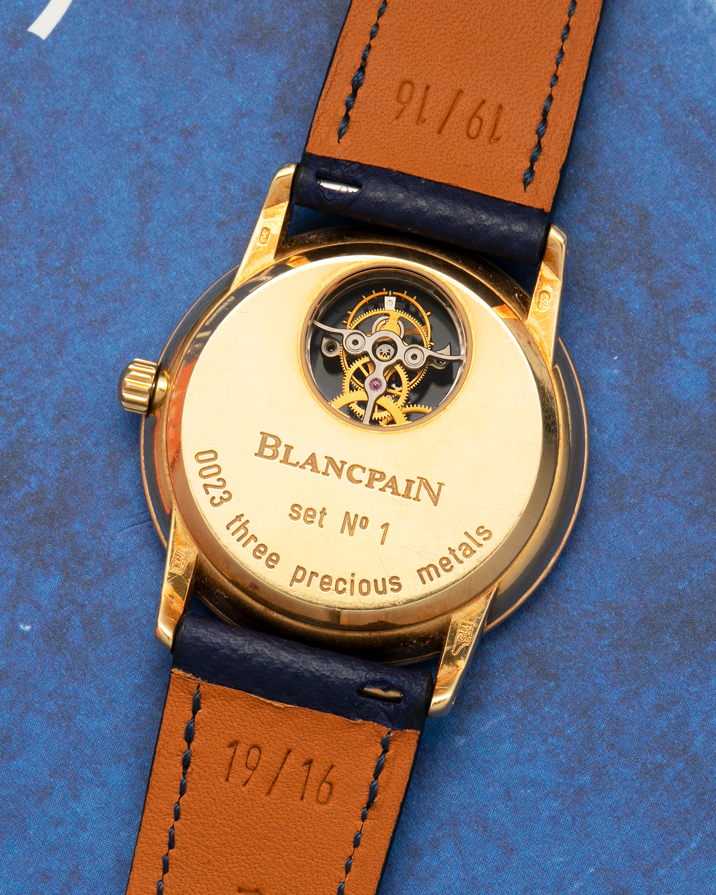 Brand: Blancpain
Year: 1996
Model: Villeret Flying Tourbillon 8 Days, Limited to 99 Pieces Across all Metals
Reference: 0023-1418-55
Material: 18-carat Yellow Gold
Movement: Blancpain Cal. 23, Manual-Winding Flying Tourbillon
Case Dimensions: 34mm x 7.4mm (Lug-to-Lug 40mm)
Lug Width: 19mm
Strap: Nostime Dark Navy Textured Calf Leather Strap with Signed 18-carat Tang Buckle, with extra used Blancpain Black Alligator Leather Strap