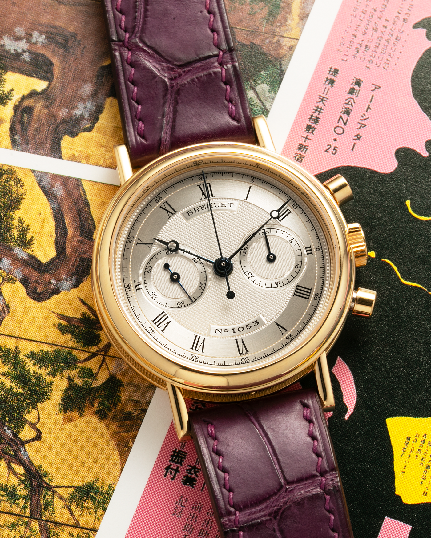 Brand: Breguet
Year: 1990’s
Model: Classique Chronograph
Reference Number: 3237
Material: 18-carat Yellow Gold
Movement: Lemania Cal. 2310, Manual-Winding
Case Dimensions: 36mm x 10mm (Lug-to-Lug 44mm)
Lug Width: 18mm
Strap: Unbranded Dark Purple Alligator Leather Strap with Signed 18-carat Yellow Gold Breguet Tang Buckle