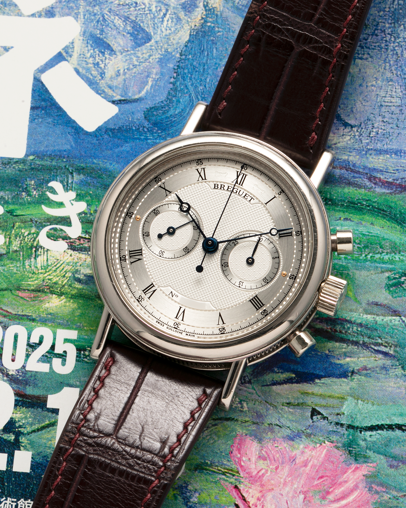 Brand: Breguet
Year: 2006
Model: Classique Chronograph
Reference Number: 5237
Material: 18-carat White Gold
Movement: Breguet Cal. 533.3 (Based on the Lemania Cal. 2320), Manual-Winding
Case Dimensions: 38mm x 10.5mm (Lug-to-Lug 45.2mm)
Lug Width: 20mm
Strap: ZousViet Dark Brown Stitched Alligator Leather Strap with Signed 18-carat White Gold Deployant Clasp
