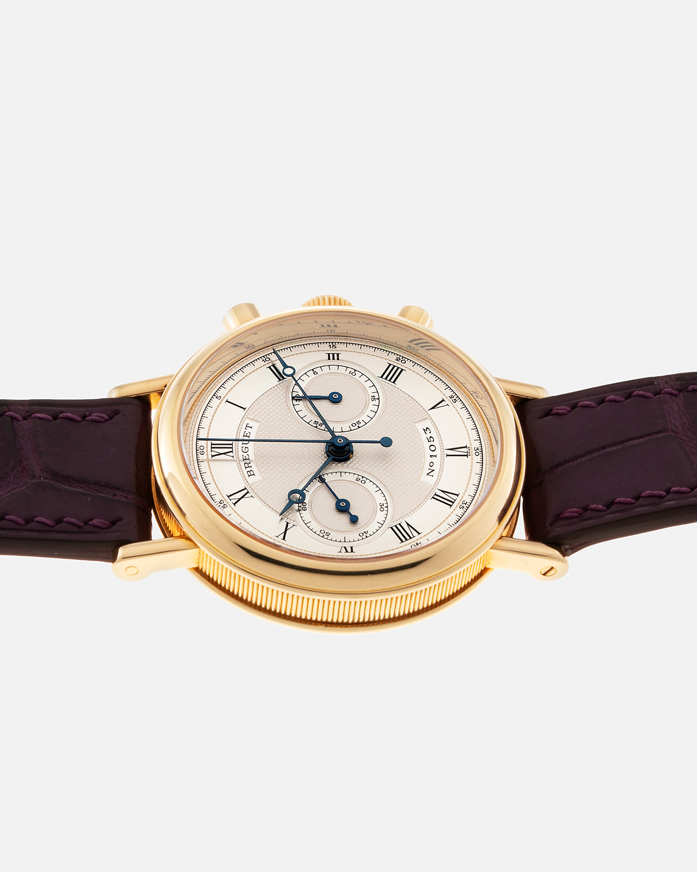 Brand: Breguet Year: 1990’s Model: Classique Chronograph Reference Number: 3237 Material: 18-carat Yellow Gold Movement: Lemania Cal. 2310, Manual-Winding Case Diameter: 36mm Lug Width: 18mm Strap: Unbranded Dark Purple Alligator Leather Strap with Signed 18-carat Yellow Gold Breguet Tang Buckle