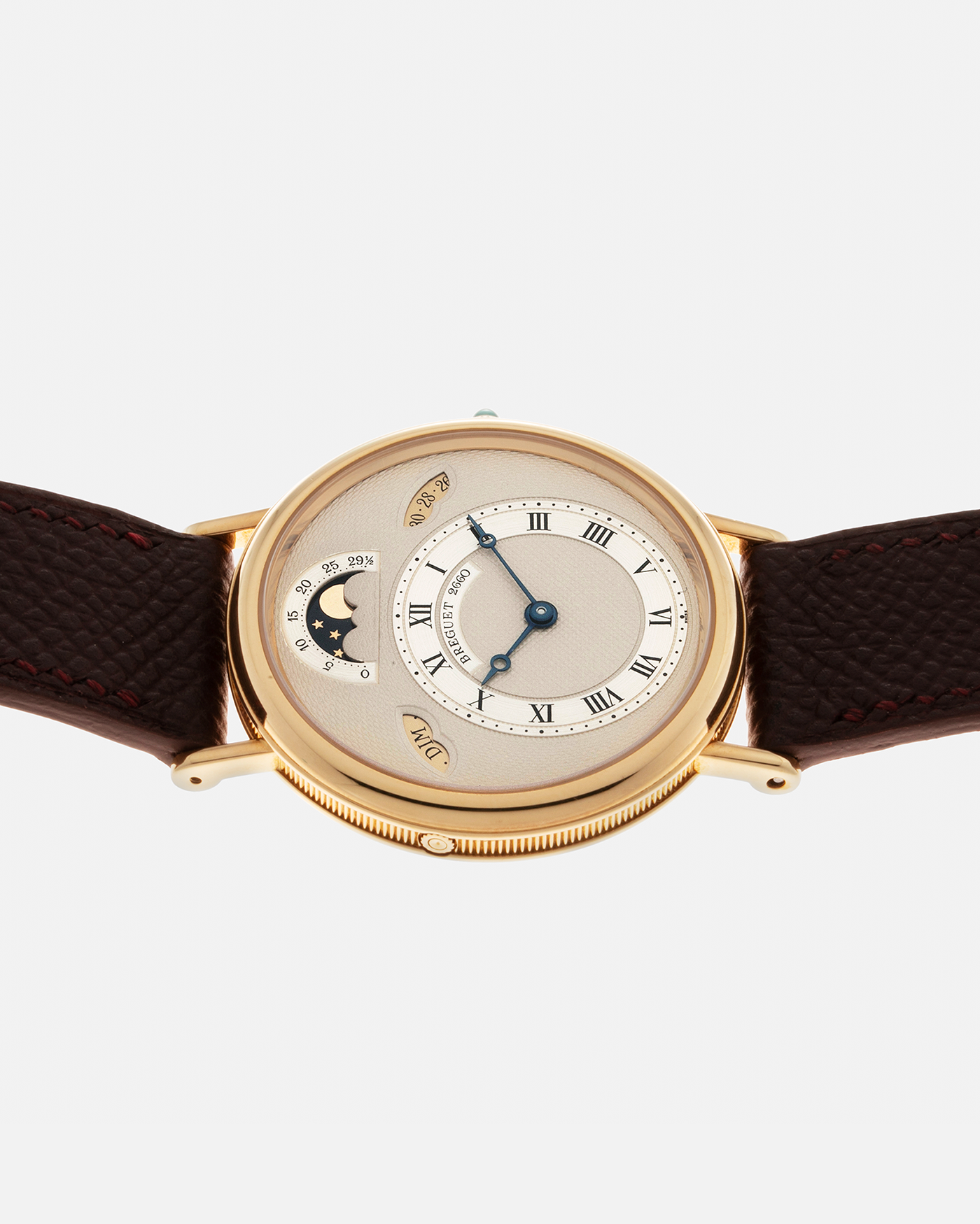 Brand: Breguet Year: 1990’s Model: Classique Day-Date Moon Phase Reference: 3337 Material: 18-carat Yellow Gold Movement: Breguet Cal. 502, Self-Winding Case Diameter: 36mm Lug Width: 18mm Strap: Generic Mahogany Brown Textured Calf Leather with Signed 18-carat Yellow Gold Tang Buckle