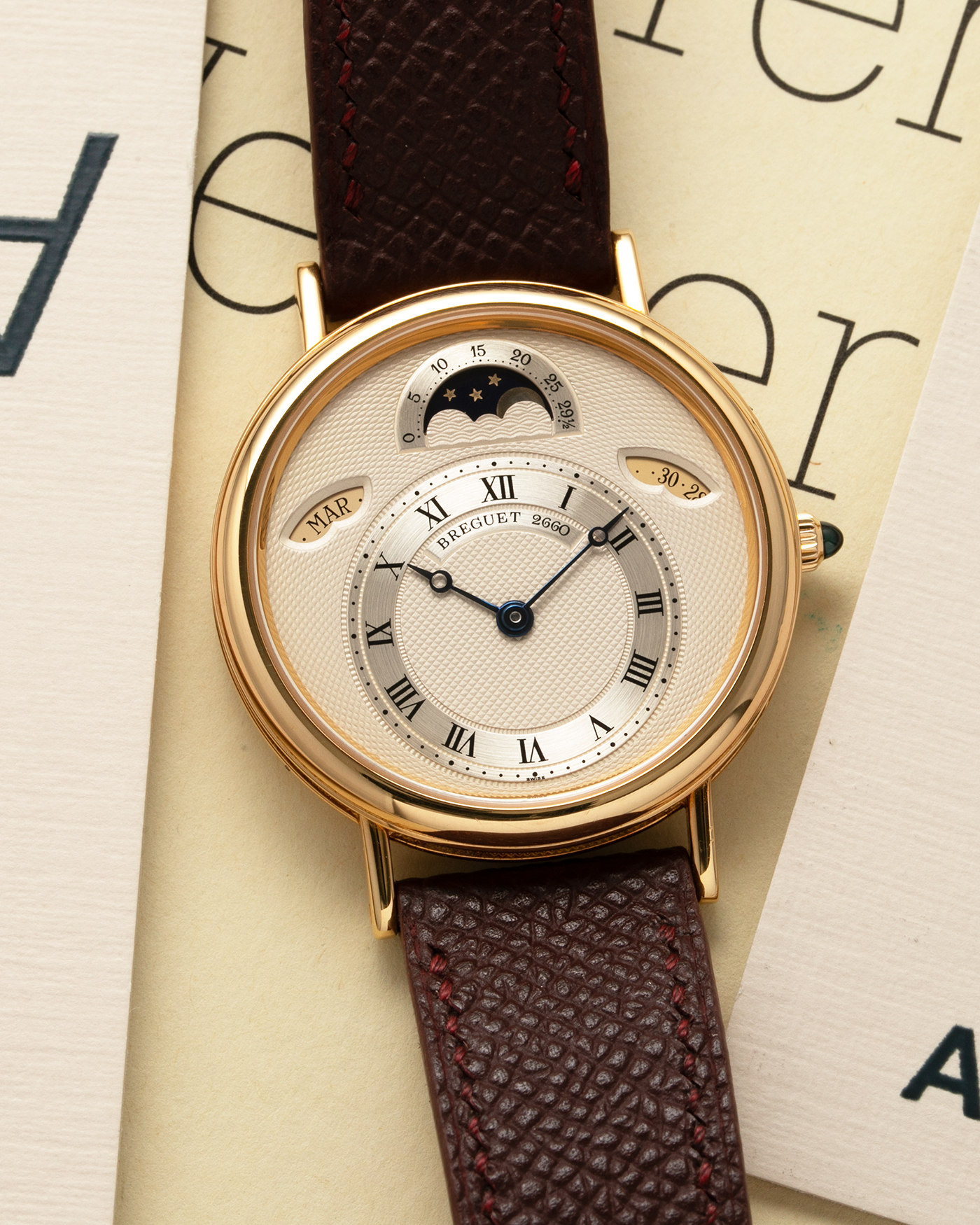Brand: Breguet Year: 1990’s Model: Classique Day-Date Moon Phase Reference: 3337 Material: 18-carat Yellow Gold Movement: Breguet Cal. 502, Self-Winding Case Diameter: 36mm Lug Width: 18mm Strap: Generic Mahogany Brown Textured Calf Leather with Signed 18-carat Yellow Gold Tang Buckle