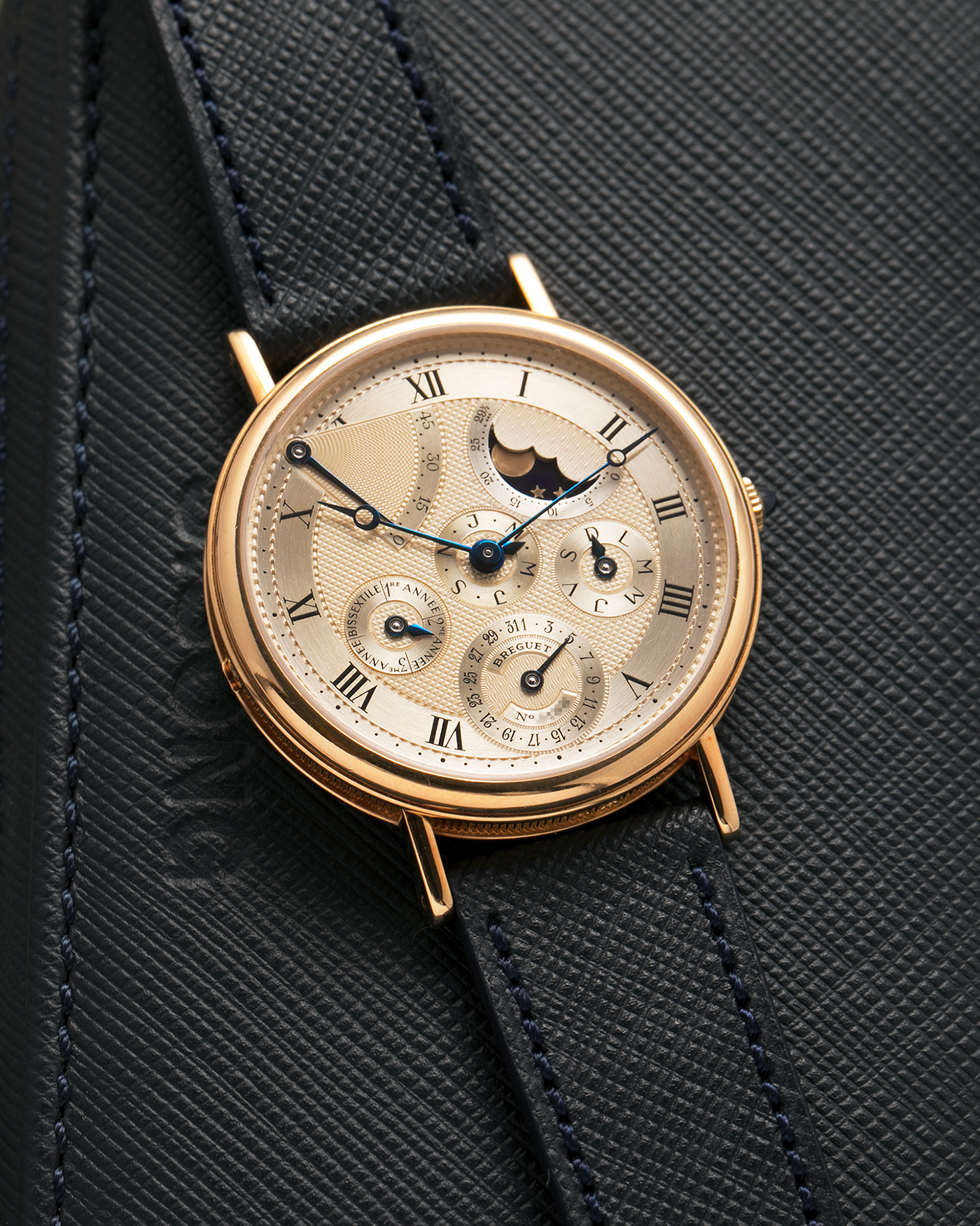 Brand: Breguet
Year: 1994 C Series
Model: Classique Quantième Perpétuel
Reference: 3310BA
Material: 18-carat Yellow Gold
Movement: Breguet Cal. 502 DRP, Self-Winding (based on the Frédéric Piguet Cal. 71)
Case Dimensions: 36mm x 8mm (Lug-to-Lug mm 43.5mm)
Lug Width: 18 mm
Strap: Molequin Dark Navy Textured Calf Leather Strap with Signed 18-carat Yellow Gold Tang Buckle
