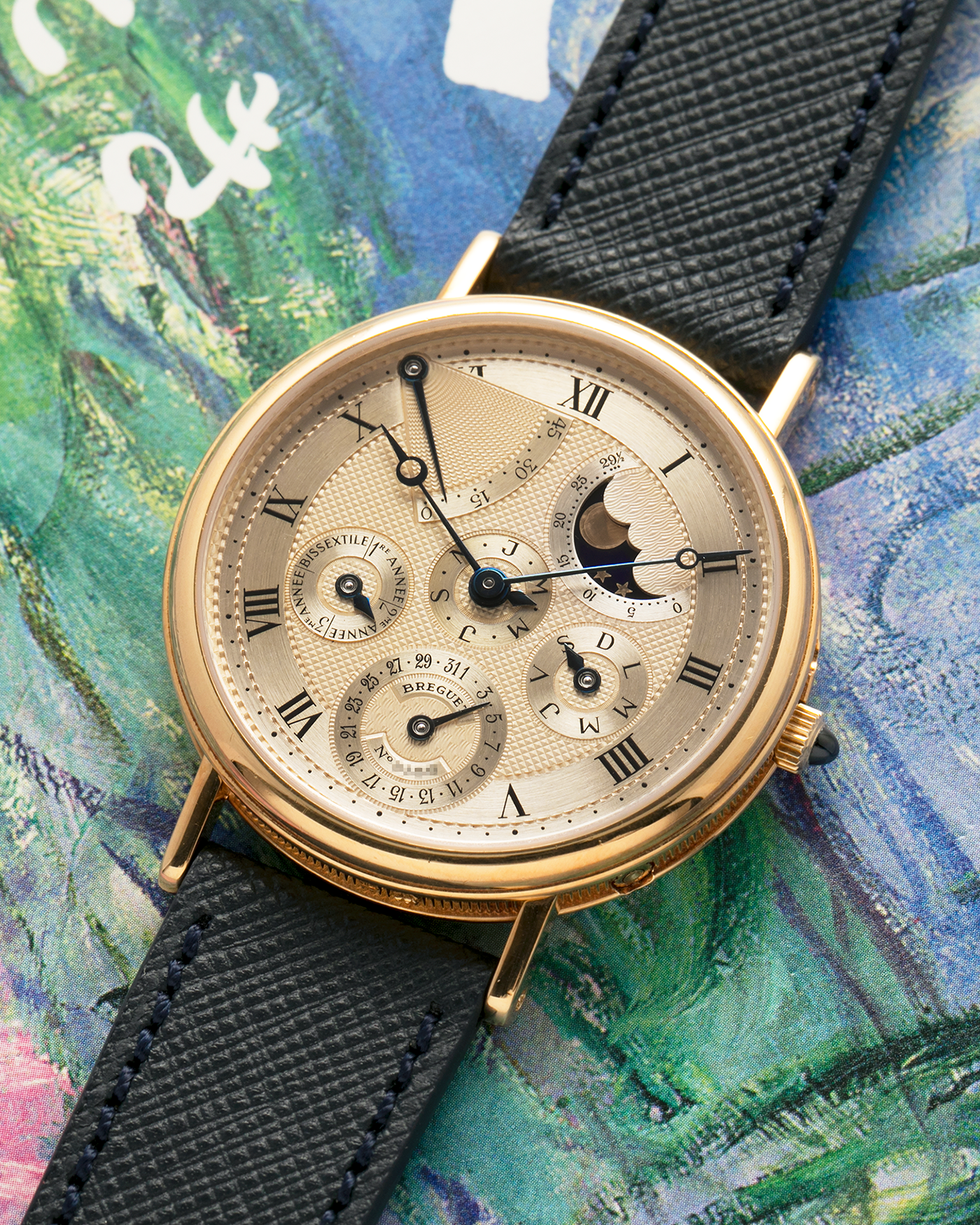 Brand: Breguet
Year: 1994 C Series
Model: Classique Quantième Perpétuel
Reference: 3310BA
Material: 18-carat Yellow Gold
Movement: Breguet Cal. 502 DRP, Self-Winding (based on the Frédéric Piguet Cal. 71)
Case Dimensions: 36mm x 8mm (Lug-to-Lug mm 43.5mm)
Lug Width: 18 mm
Strap: Molequin Dark Navy Textured Calf Leather Strap with Signed 18-carat Yellow Gold Tang Buckle