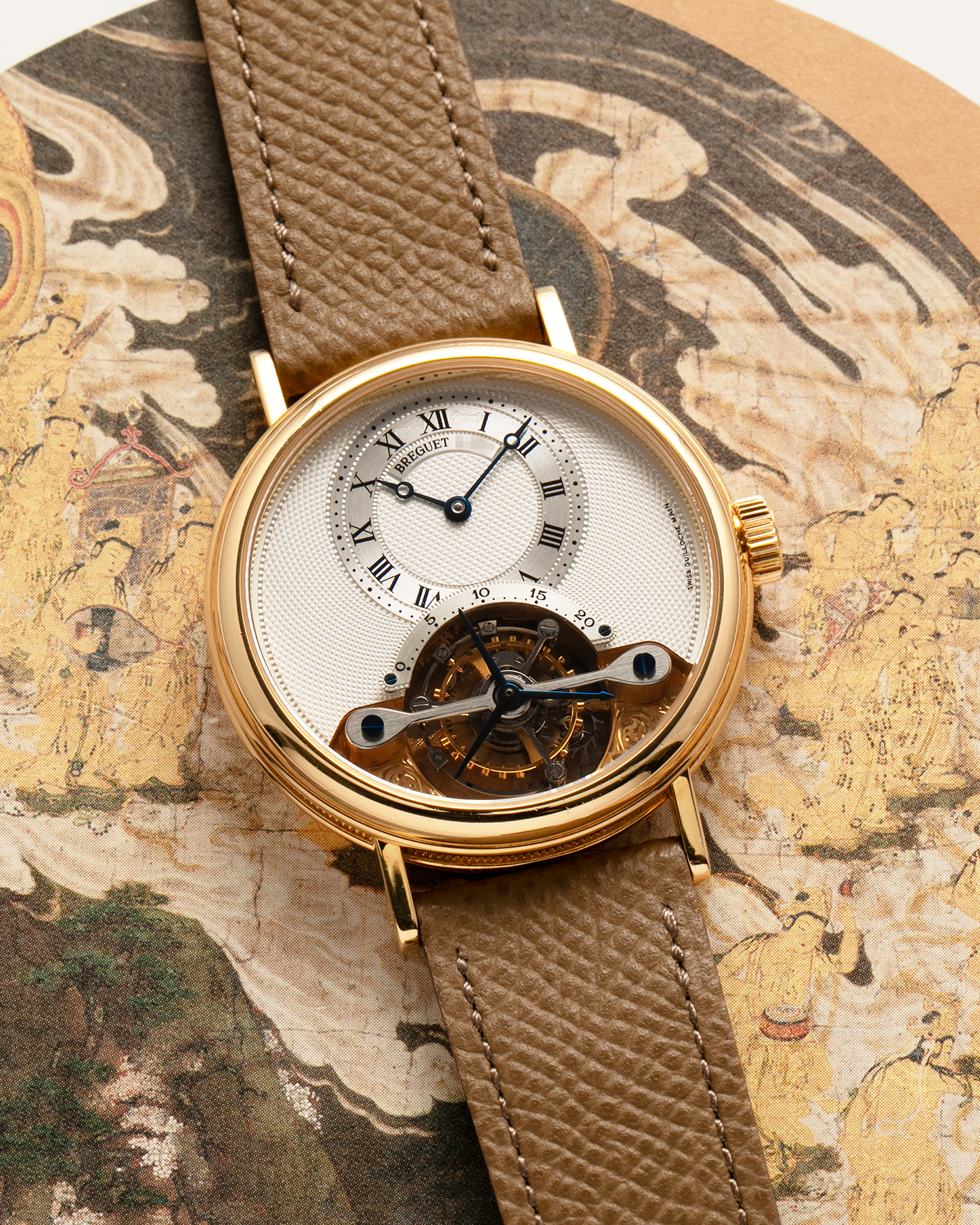 Brand: Breguet
Year: 2000-2001, K Series
Model: Classique Tourbillon
Reference: 3357BA
Material: 18-carat Yellow Gold
Movement: Breguet Cal. 558, Manually Wound One Minute Tourbillon
Case Dimensions: 35mm Diameter 9mm Thickness
Lug Width: 18 mm
Strap: Nostime Taupe Textured Calf Strap and 18k Yellow Gold Breguet Deployant