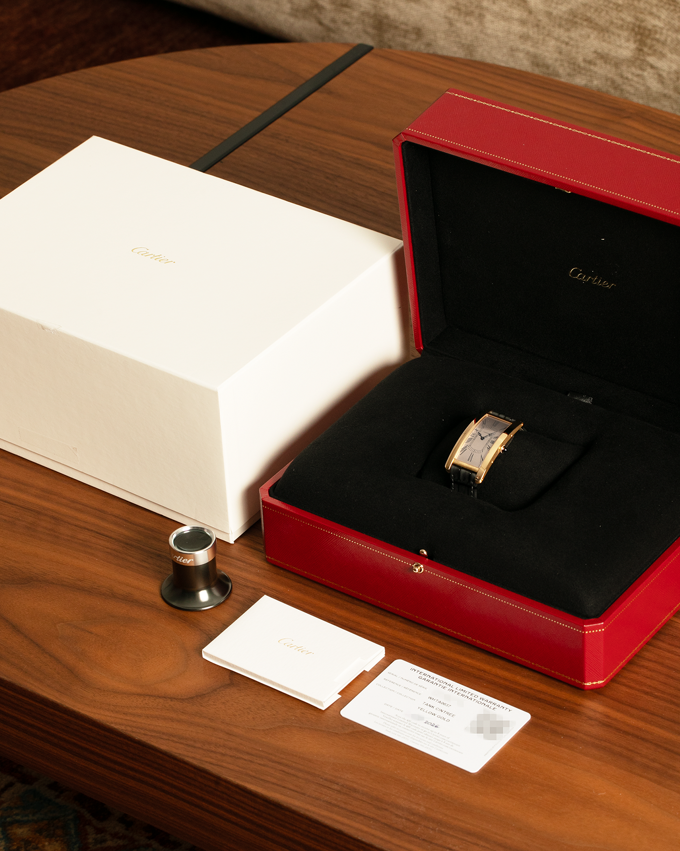 Brand: Cartier
Year: 2026
Model: Privé La Collection Tank Cintrée
Reference: WHTA0037
Material: 18k Yellow Gold
Movement: Cartier Cal. 1917 MC, Manual-Winding
Case Diameter: 46.3mm x 23 mm (6.95mm Thick)
Lug Width: 16mm
Strap: Cartier Grey Alligator Leather Strap with Cartier Signed 18k Yellow Gold Tang Buckle