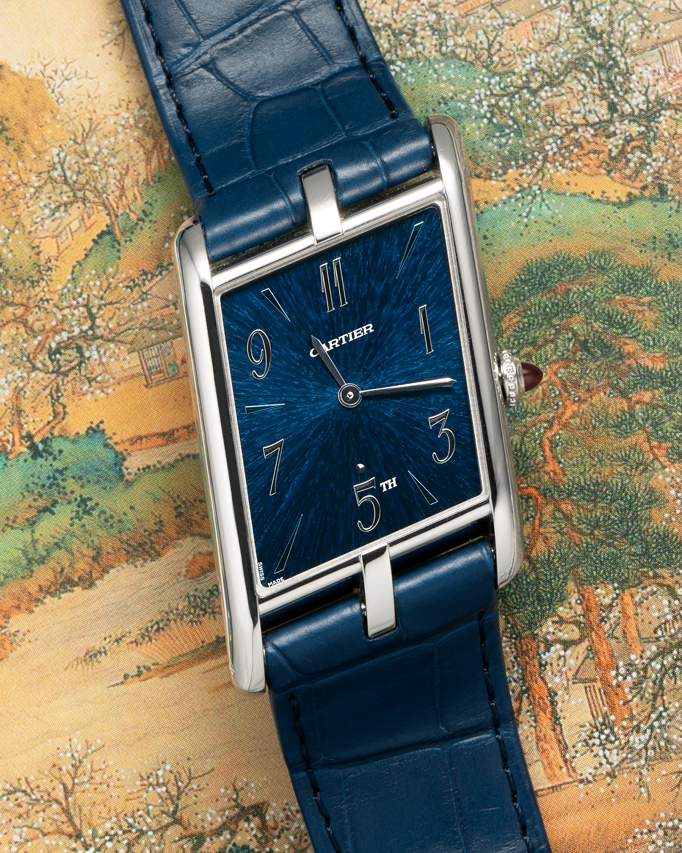 Brand: Cartier
Year: 2024
Model: Privé Tank Asymétrique 5th Ave New York Edition
Reference: WGTA0120
Material:  Platinum 950
Movement: Cartier Cal. 1917MC, Manual-Winding
Case Dimensions: 47mm x 26mm x 6.4mm (44.5mm Lug-to-Lug)
Strap: Cartier Blue Alligator Leather Strap with Signed Platinum 950 Tang Buckle